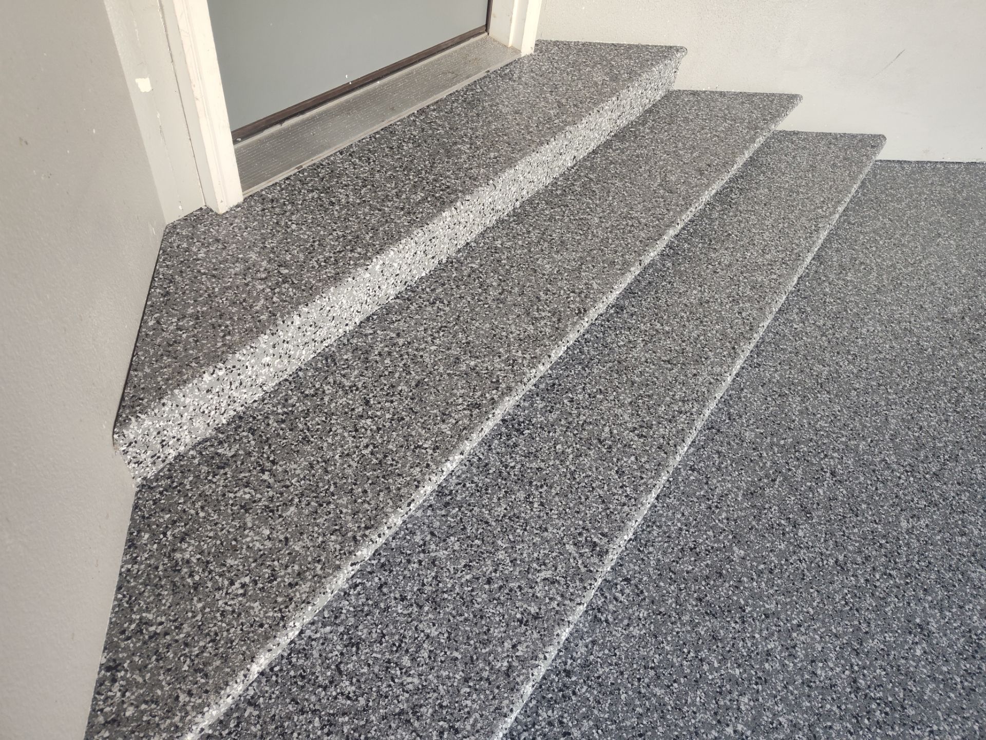 Close Up View of This Customer's New Flake Coating by Revival Concrete Coatings