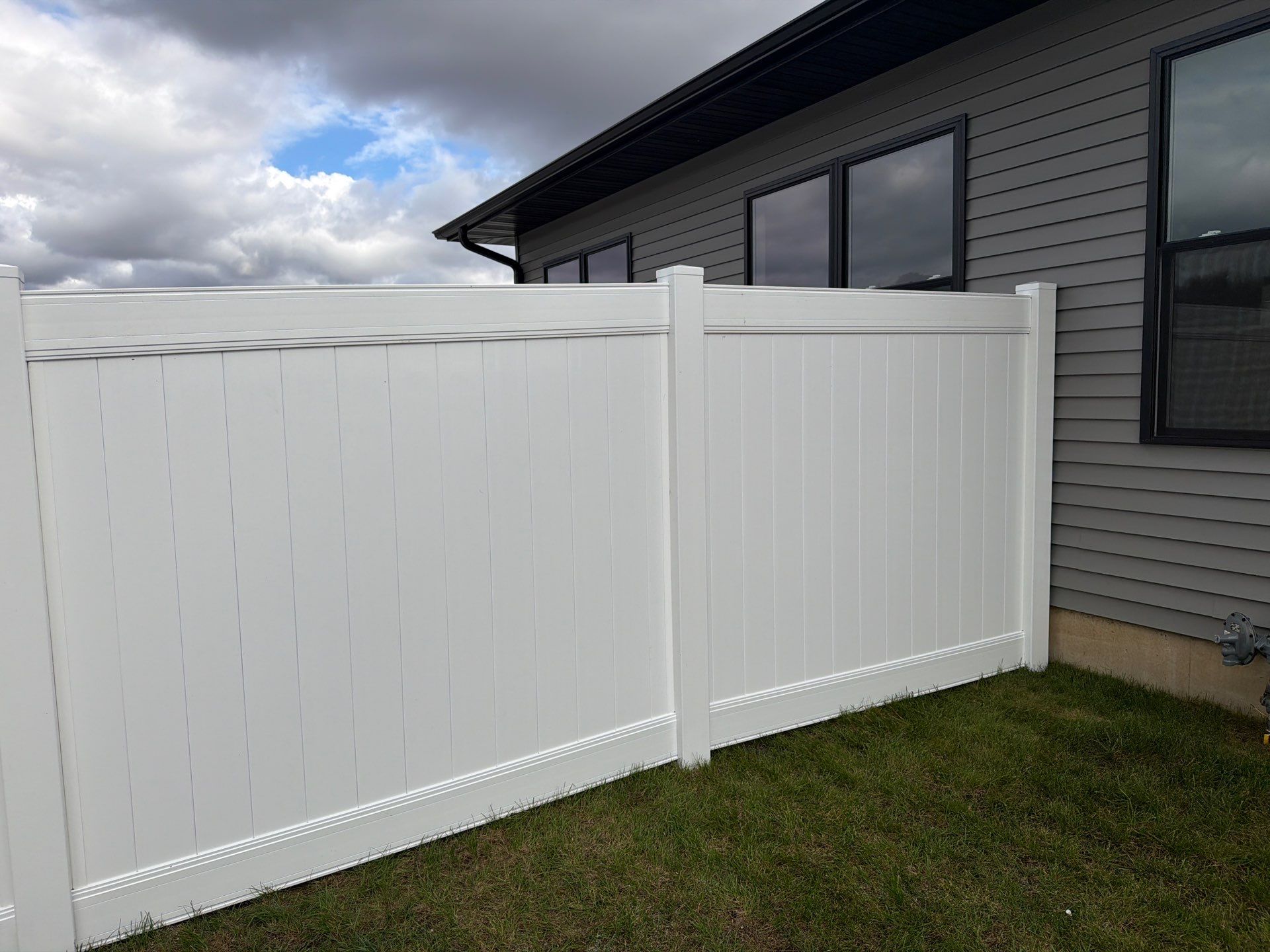 Residential White Vinyl Privacy Fence Installation in Janesville by Perfect Picket Fence and Stain