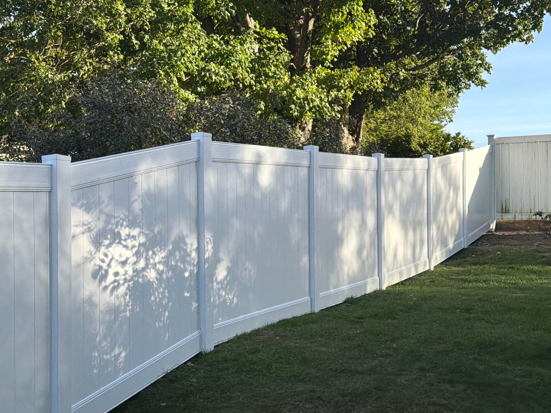 White Vinyl Privacy Fence and Gate Installation in Grundy Center by Perfect Picket Fence and Stain