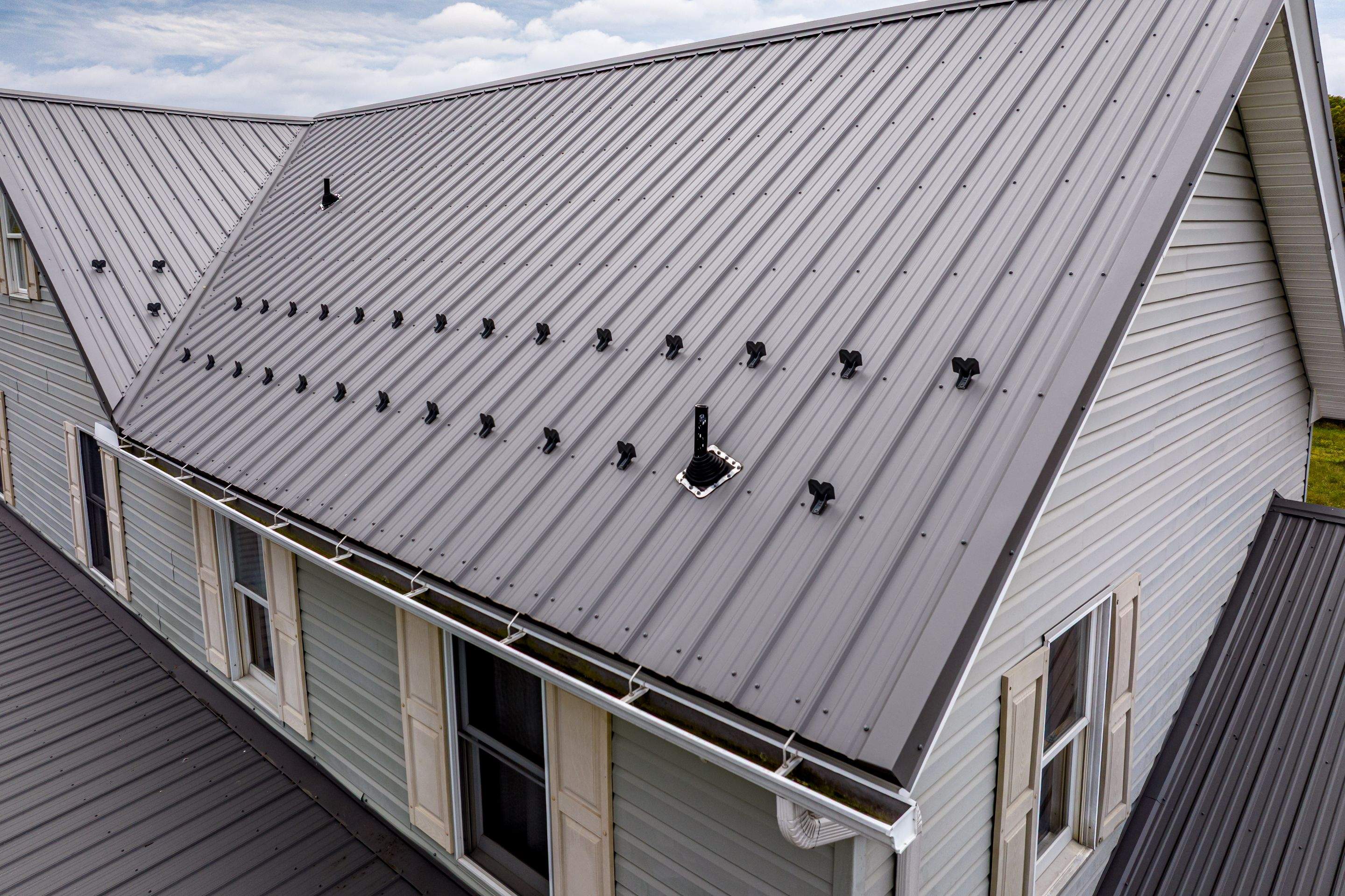 Classic Farmhouse With Textured Charcoal Metal Roof by Esh Builders