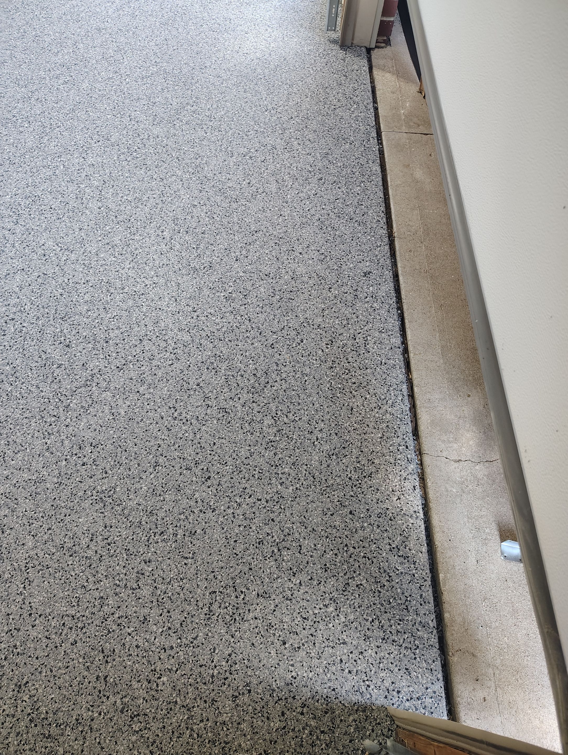 Sioux Falls Garage Concrete Grinding and Nightfall Decorative Chip Coating by Select Painting, Coatings & Garage Cabinets
