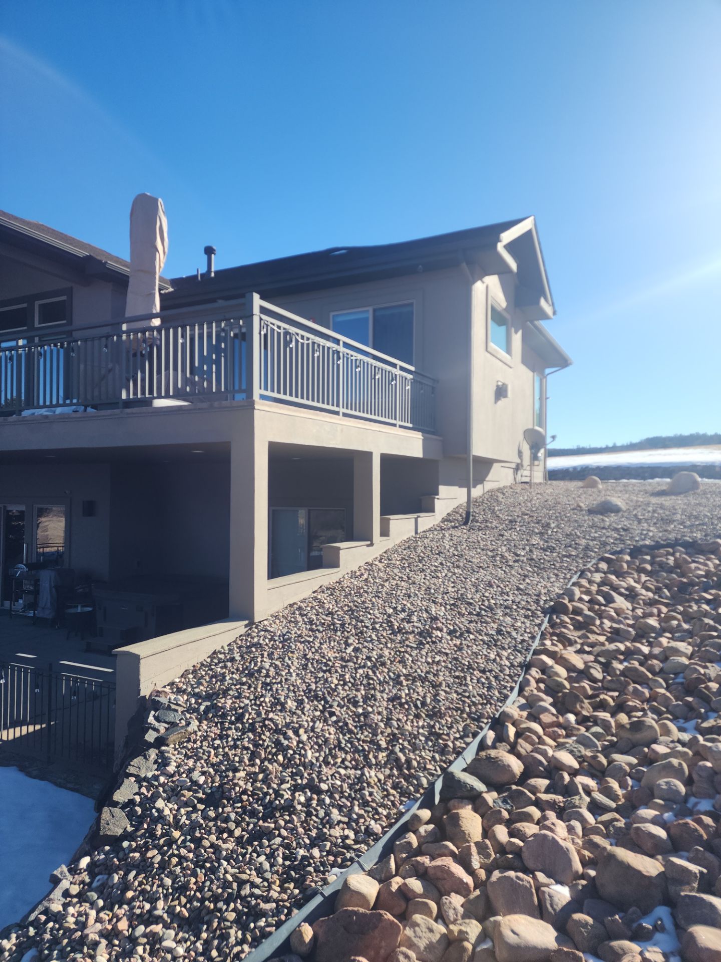 Castle Rock Elegance: White Stucco Exterior with Bold Tricorn Black by J&M Painting LLC