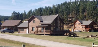 Hill Country Guest Ranch using Steel Roofing, Gutters, Log Cabin Staining