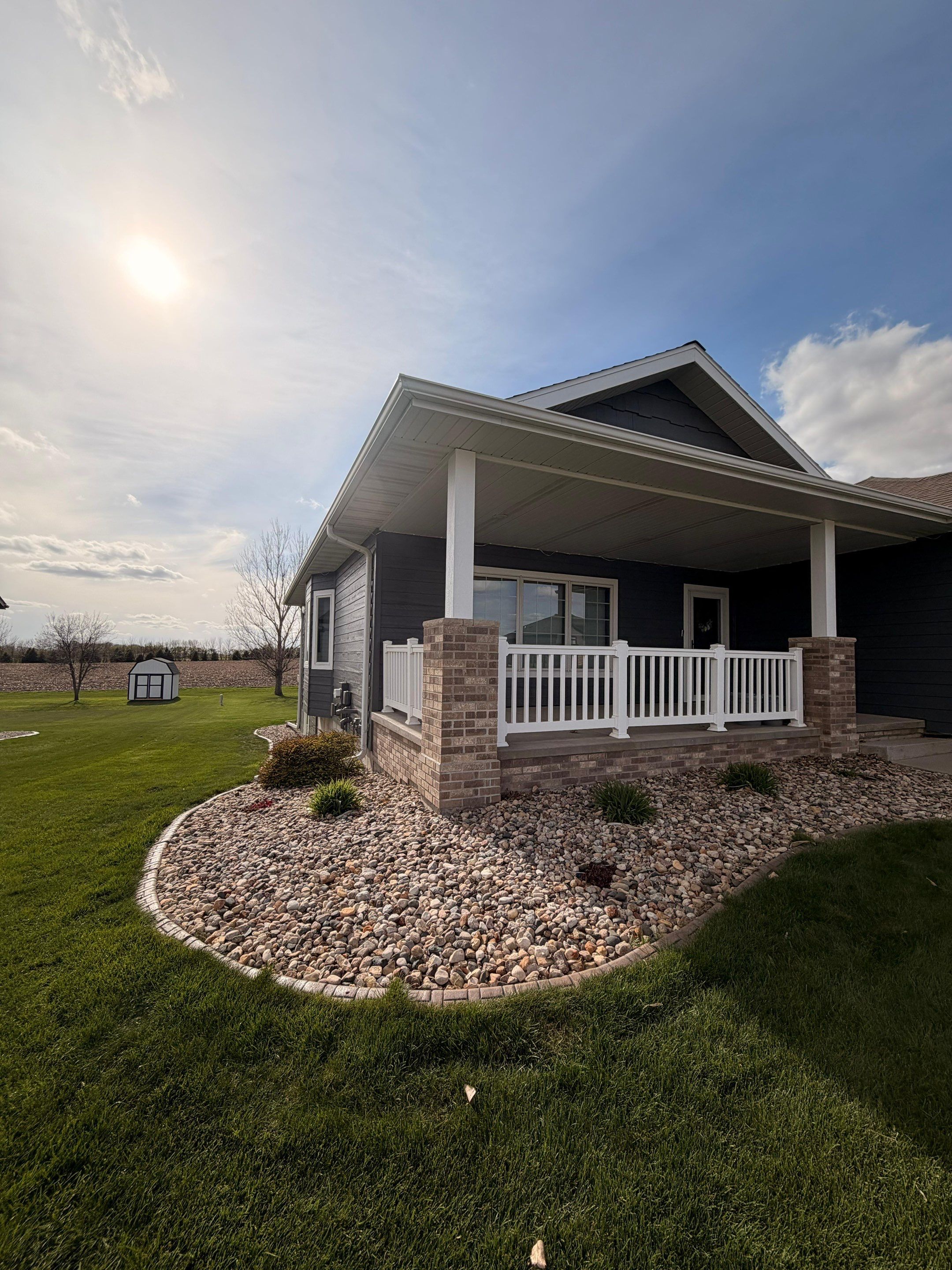Madison Exterior Remodel with Dark Gray Siding and Stone Accents by Select Painting, Coatings & Garage Cabinets