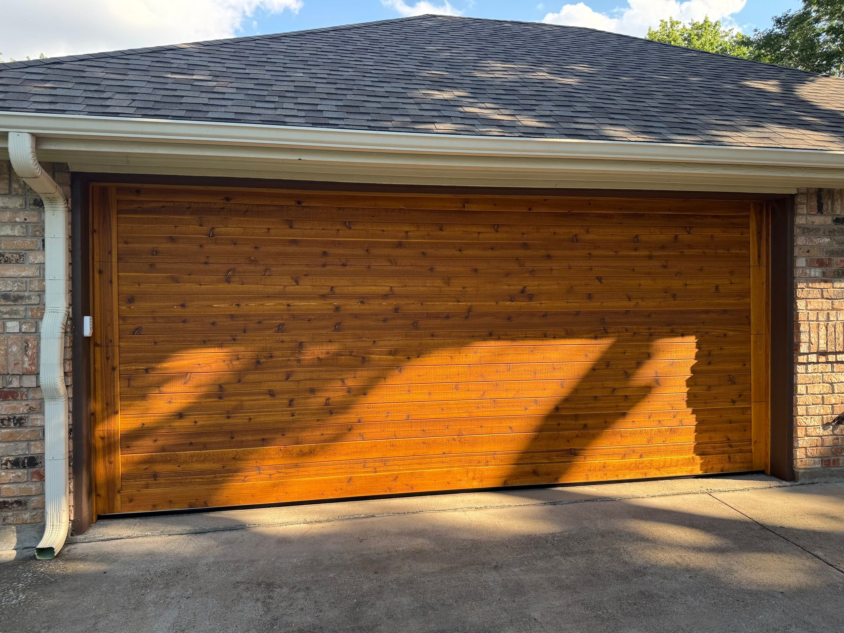 Custom Stained Cedar Garage Door Installation in Grapevine by Meadows Garage Doors