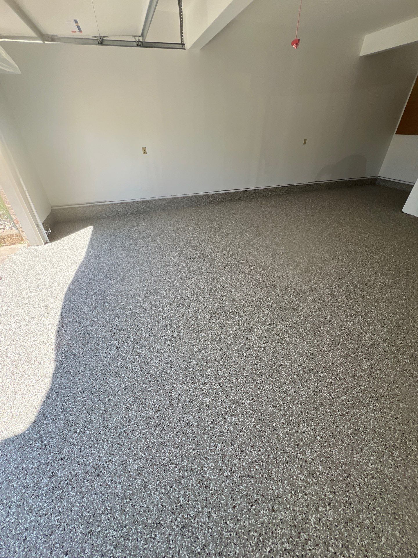 Garage floor in Holt using Smoke Flake by Freedom Concrete Coatings. 