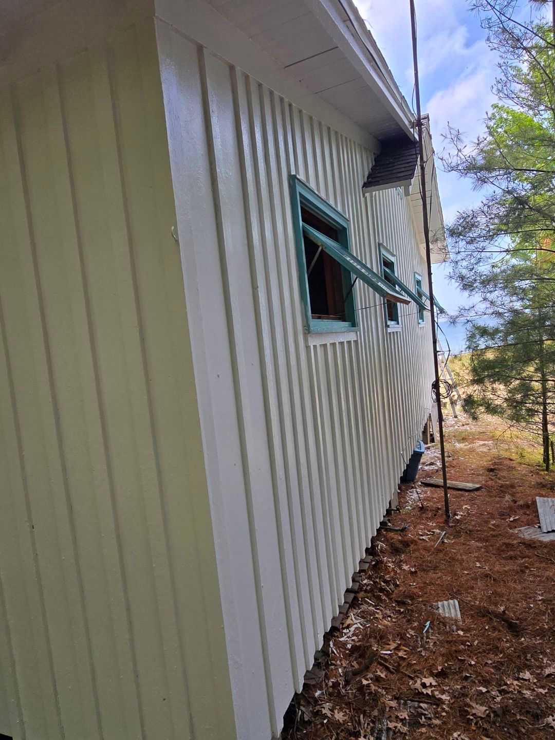 Lakeside Cottage Exterior Painting and Teal Trim Restoration in Mears by Gordon Painting