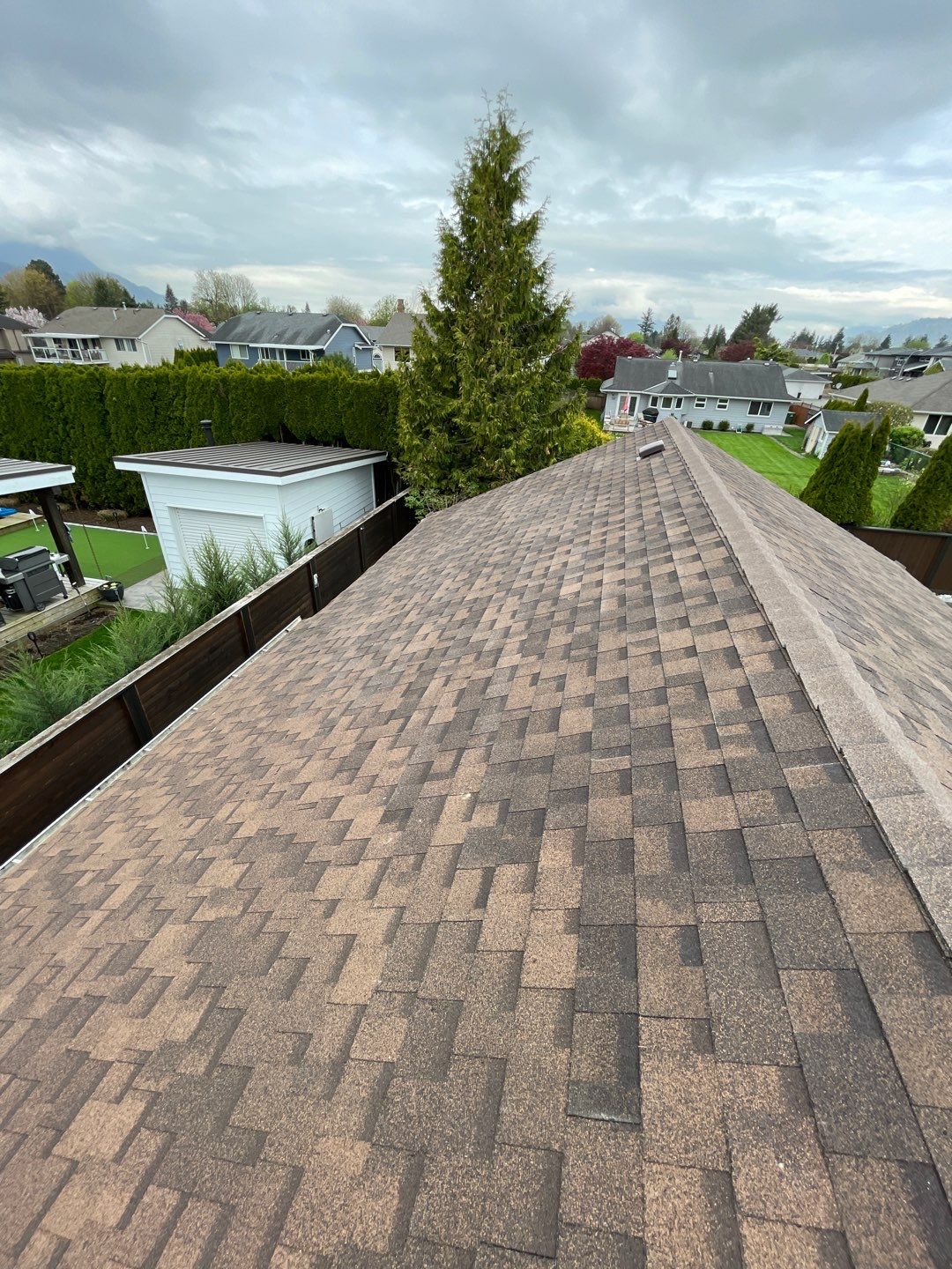 Residential patio roof extension with IKO Dual Brown shingles by Top Notch Roofing Inc