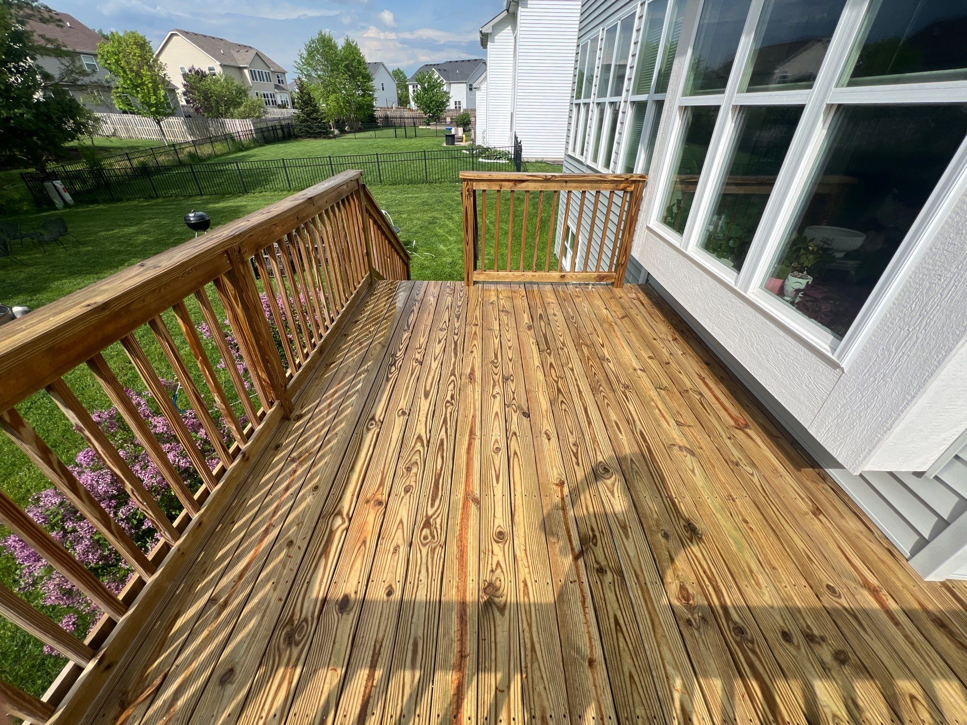 wood deck cleaning and staining by Northern Power Washing LLC.