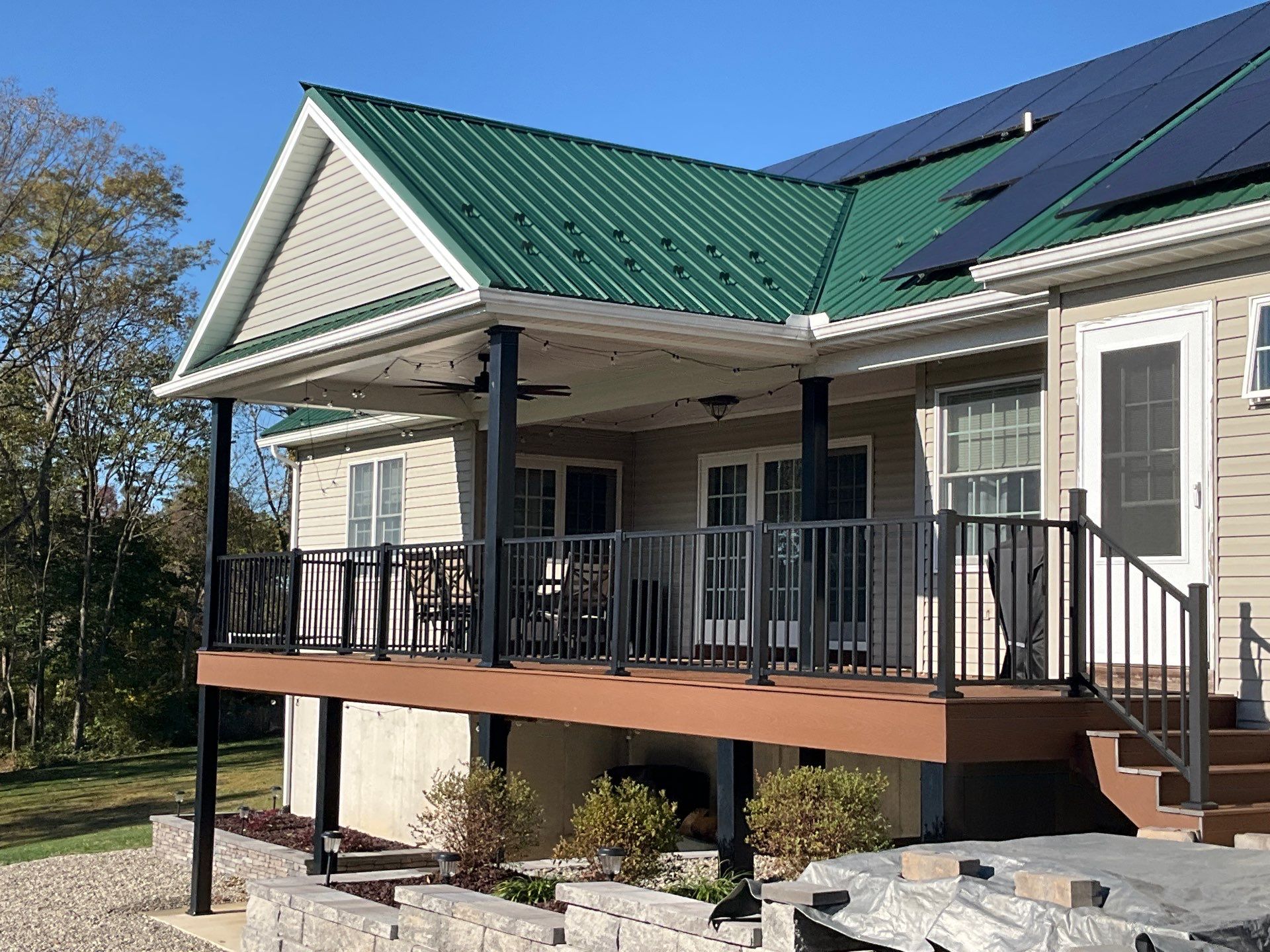 Green Metal Roof and Custom Covered Deck in Duncannon by Esh Builders
