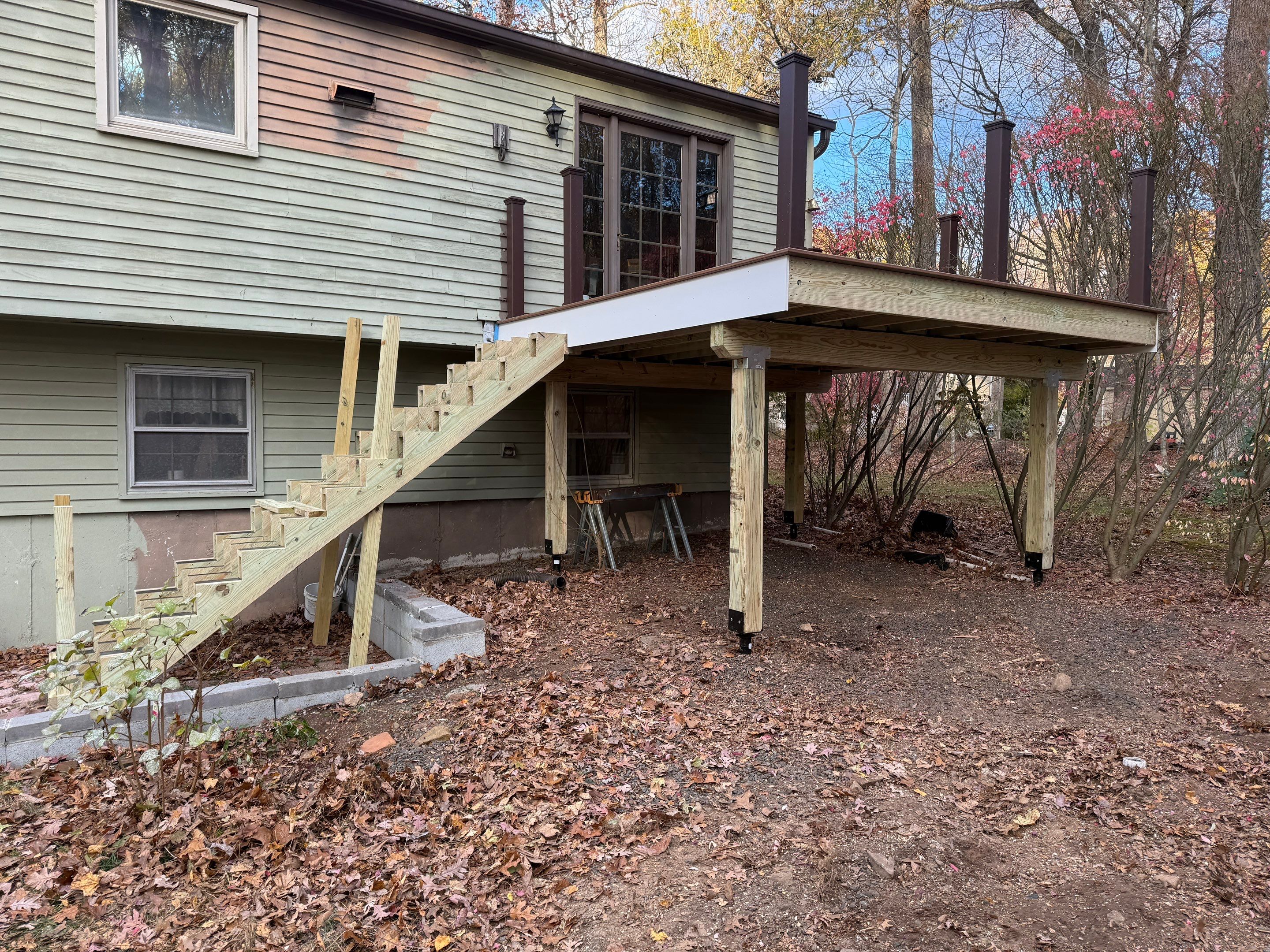 Replacement deck with Trex Tropical Tiki torch and Transcend Cocktail railings in vintage lantern. by DiGiorgi Roofing and Siding Inc
