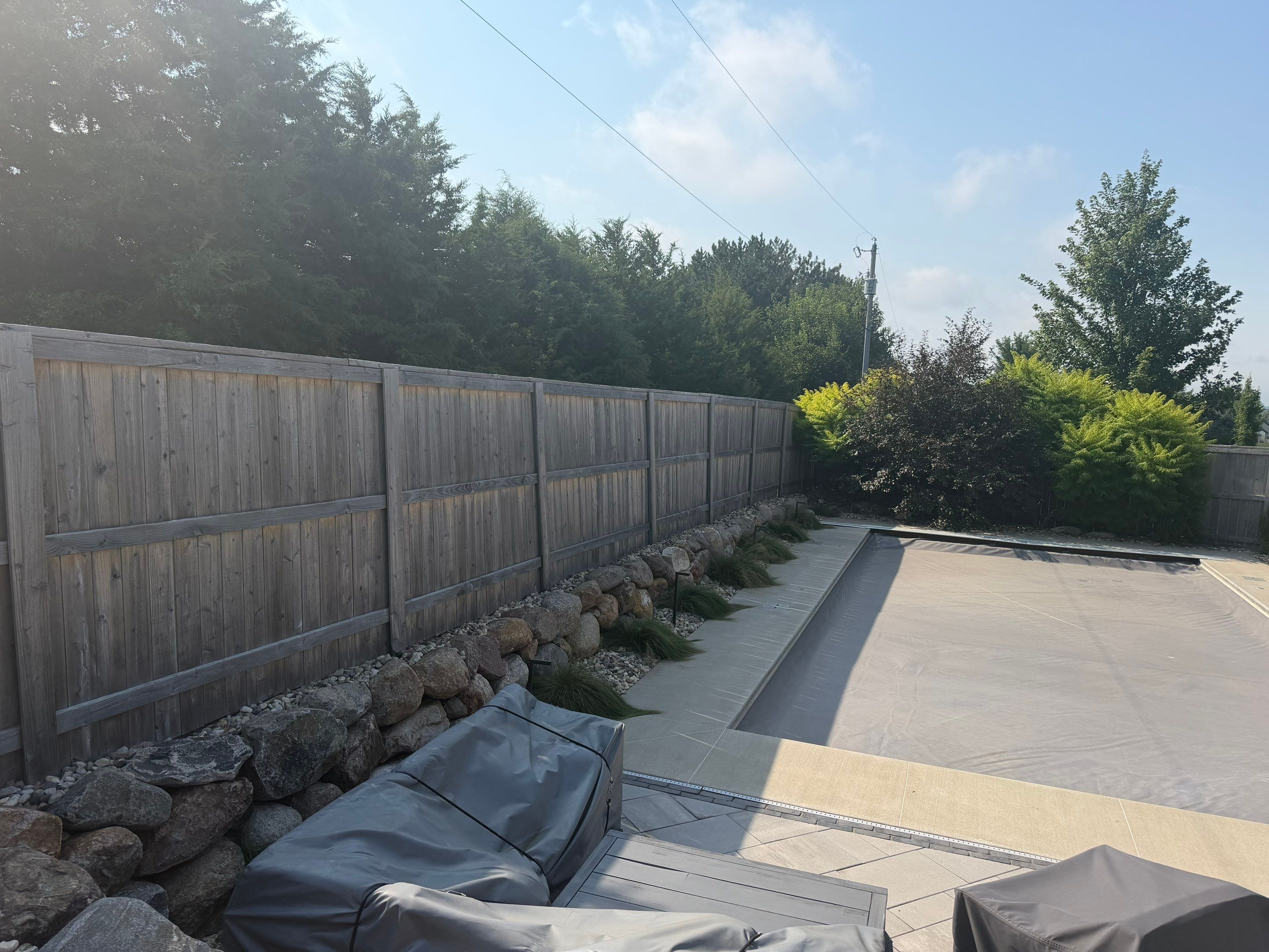 Custom Privacy Fence and Paver Patio Installation in Sioux Falls by Select Painting, Coatings & Garage Cabinets