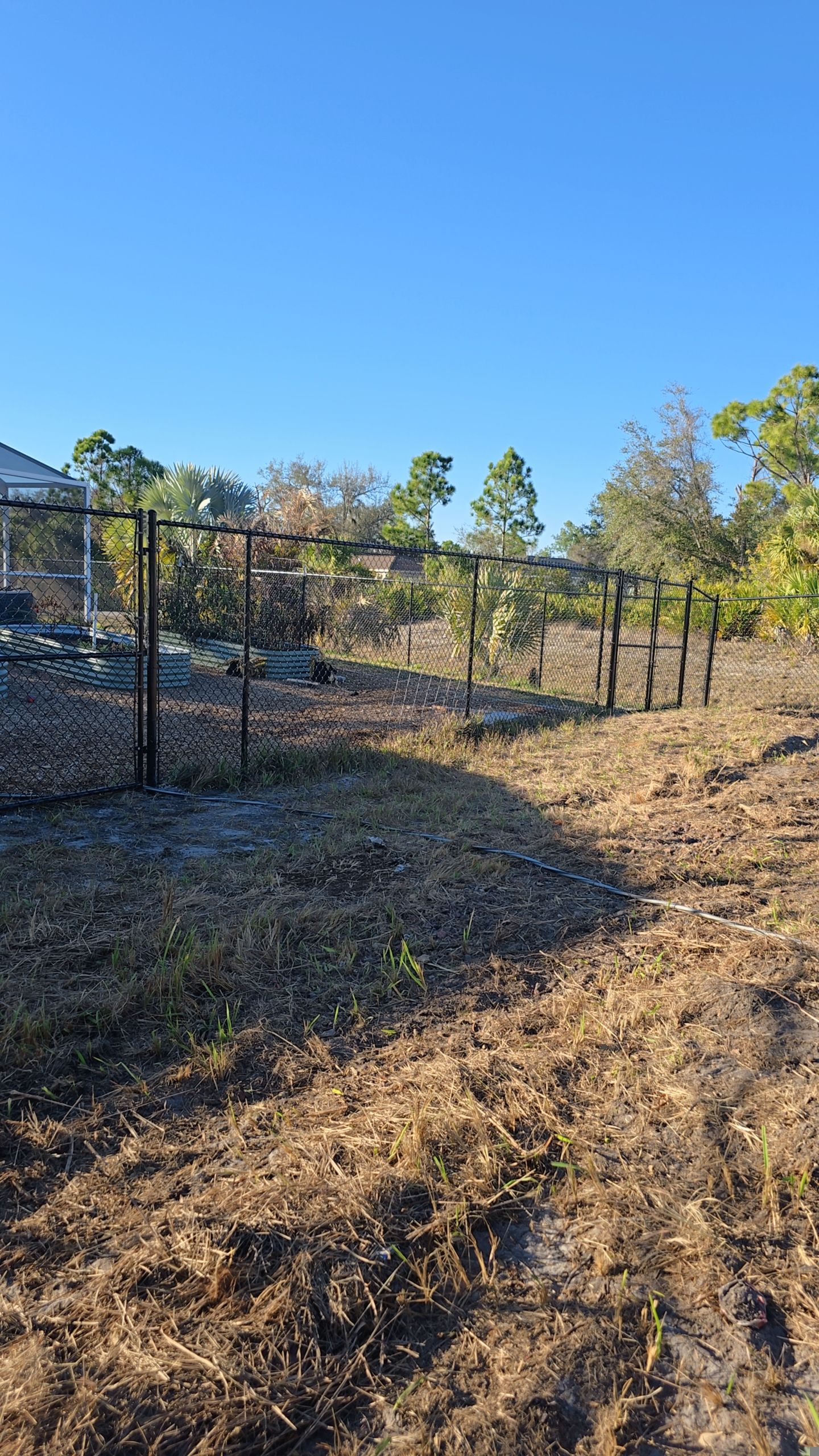Black Vinyl-Coated Chain Link Fence and Gate Installation in North Port by True Fence LLC