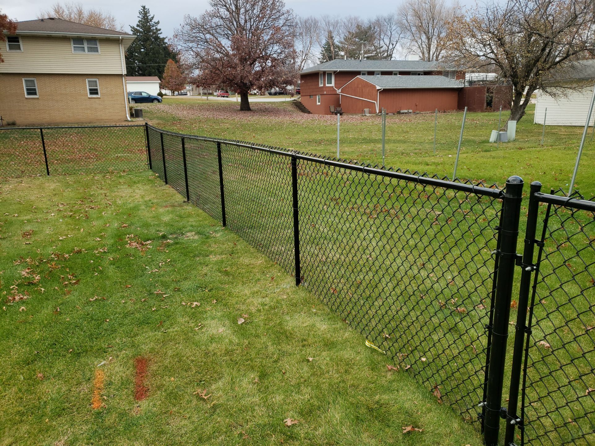Residential Black Vinyl-Coated Chain Link Fence in Grundy Center by Perfect Picket Fence and Stain