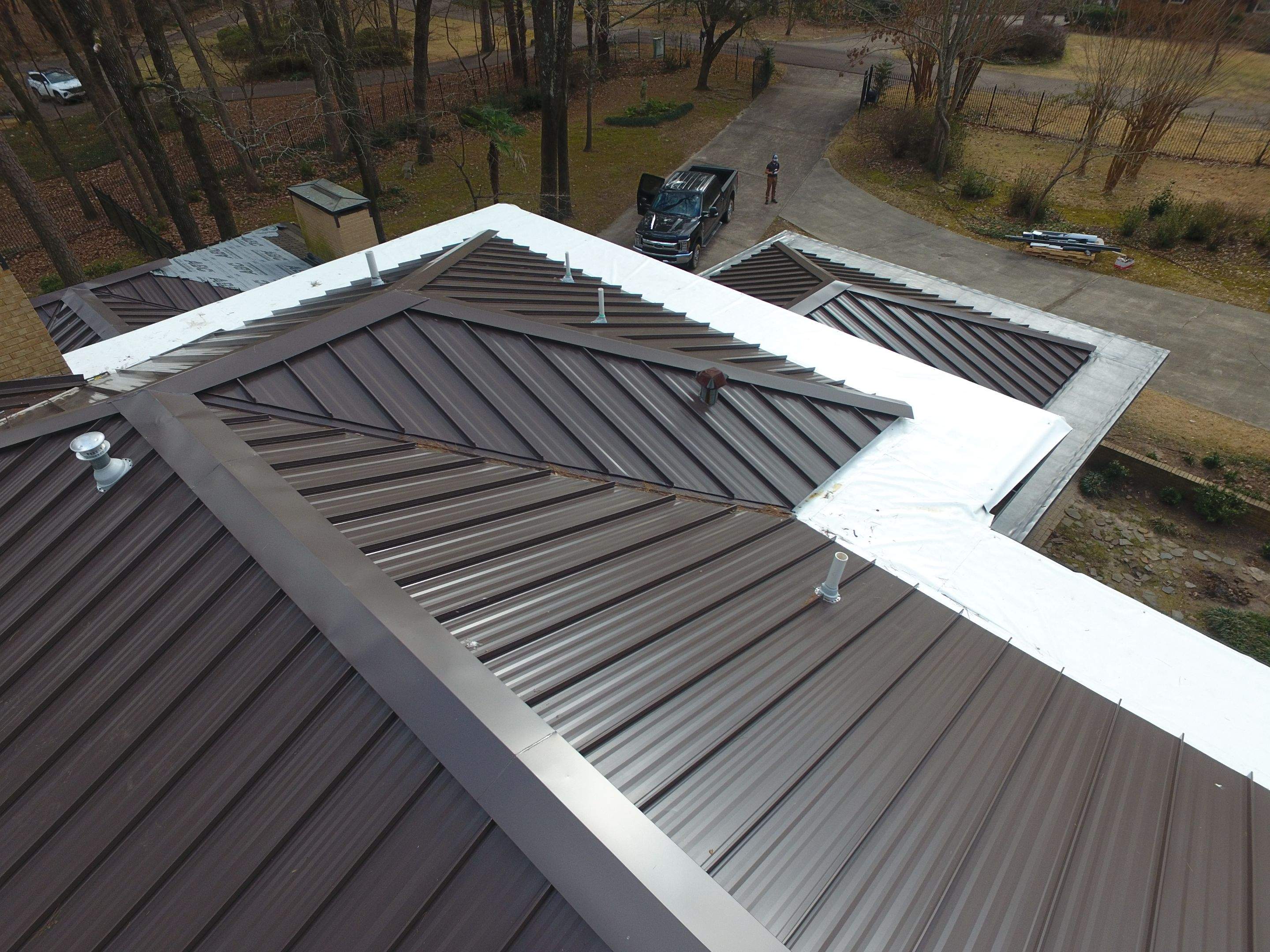 Residential Roofing Installation using PVC membrane and 24 gauge Standing Seam Metal by Hostetler Roofing