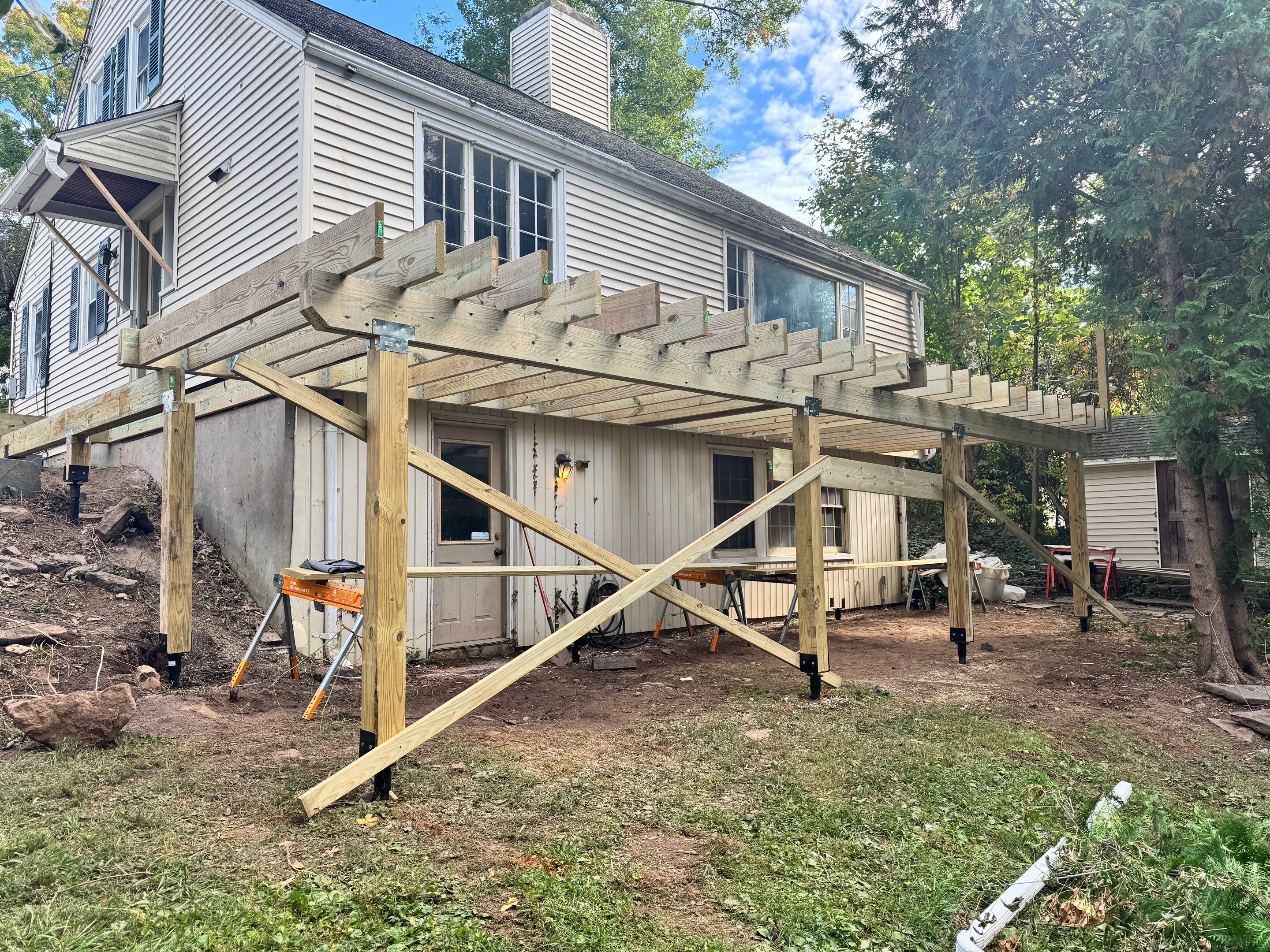 New Deck, Trex Select Pebble Gray boards, Composite railings in white, Trex Rainescape system, and gate. by DiGiorgi Roofing and Siding Inc