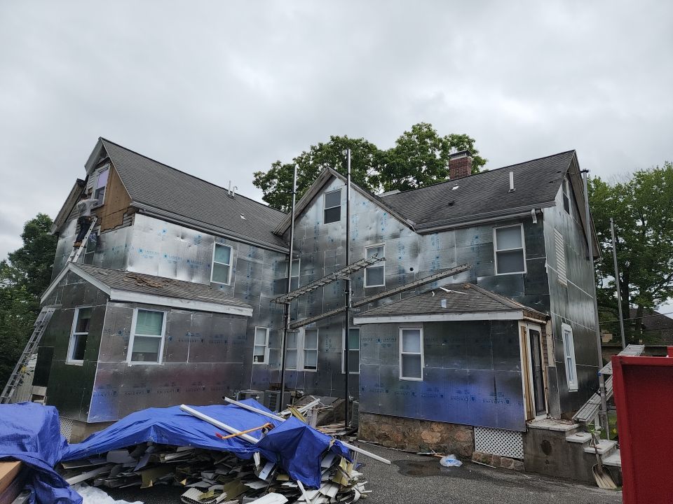 Vinyl siding layover project for 2 family in Wellesley, MA by UBrothers Construction