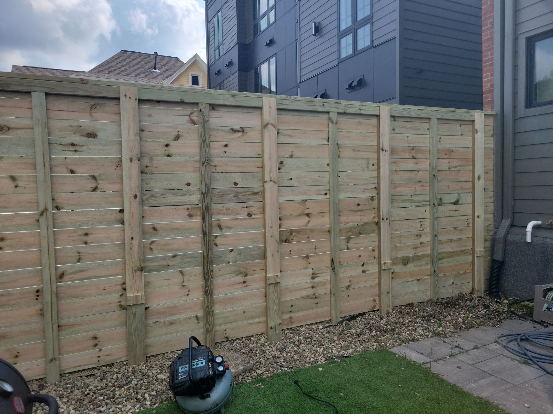Modern Horizontal Slat Wood Privacy Fence Installation in Cedar Falls by Perfect Picket Fence and Stain