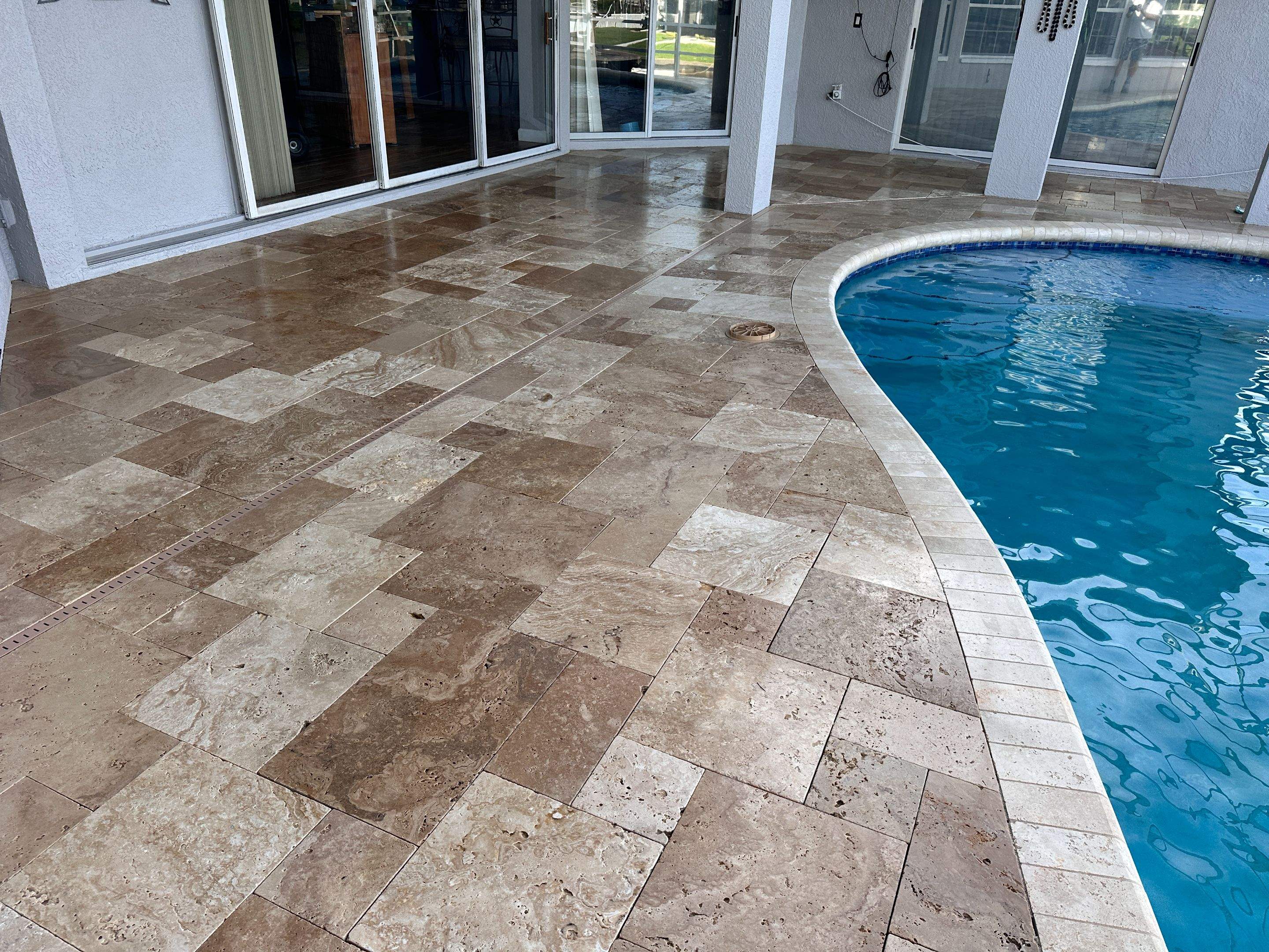 Travertine Sealing and Stripping for a Waterfront Pool Deck in Apollo Beach by Supreme Paver Experts