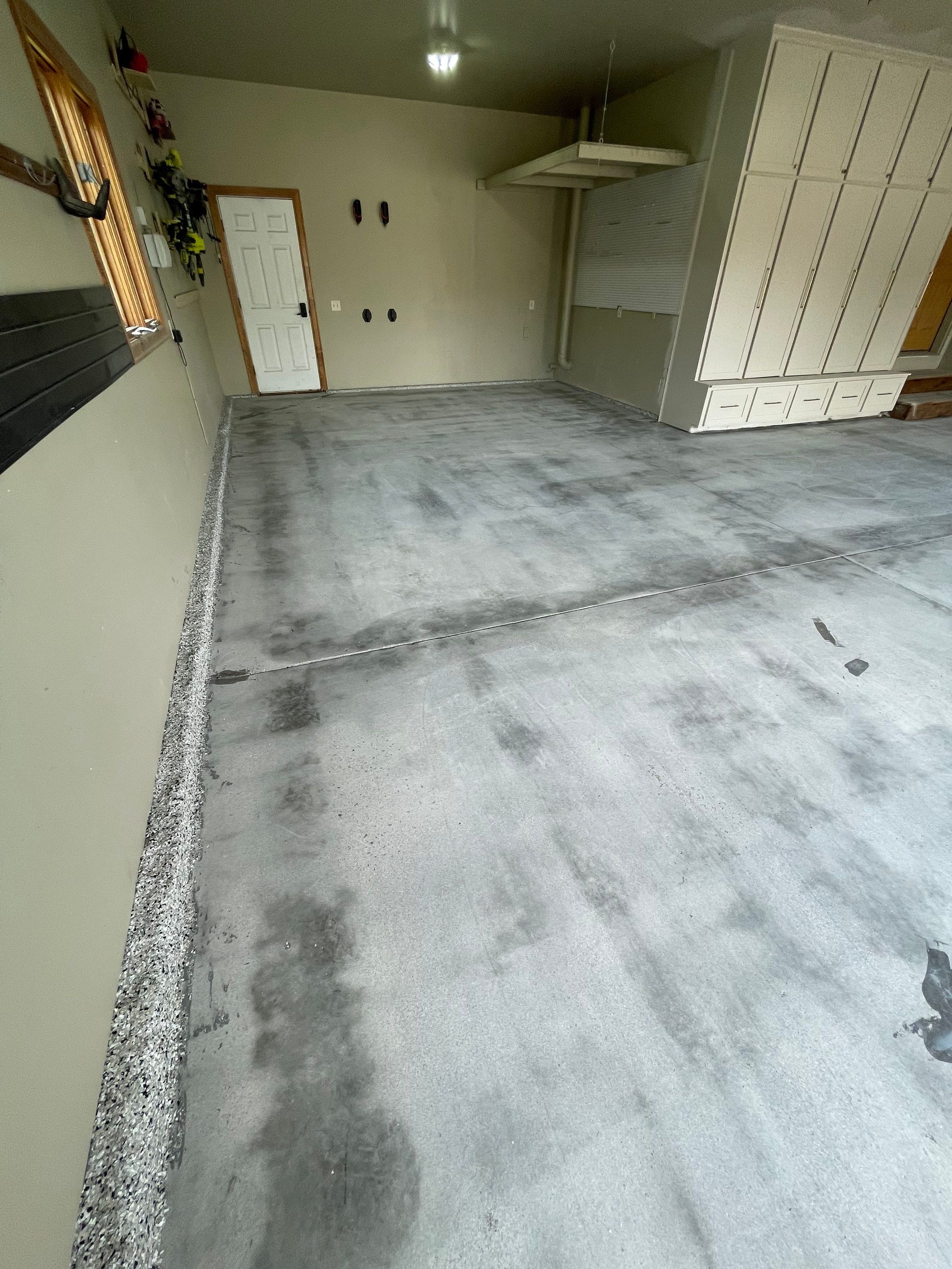 Cabin FEver Flake Garage Floor Coating Installation in Sioux Falls by Select Painting, Coatings & Garage Cabinets