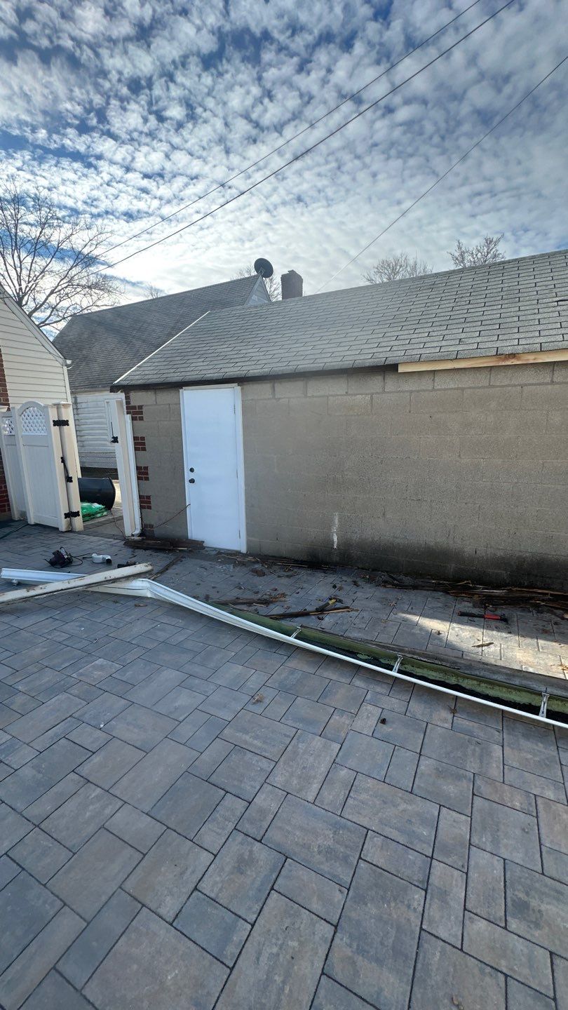 Queens Garage Fascia Rebuild + New 5" Seamless Gutter by Above All Gutters