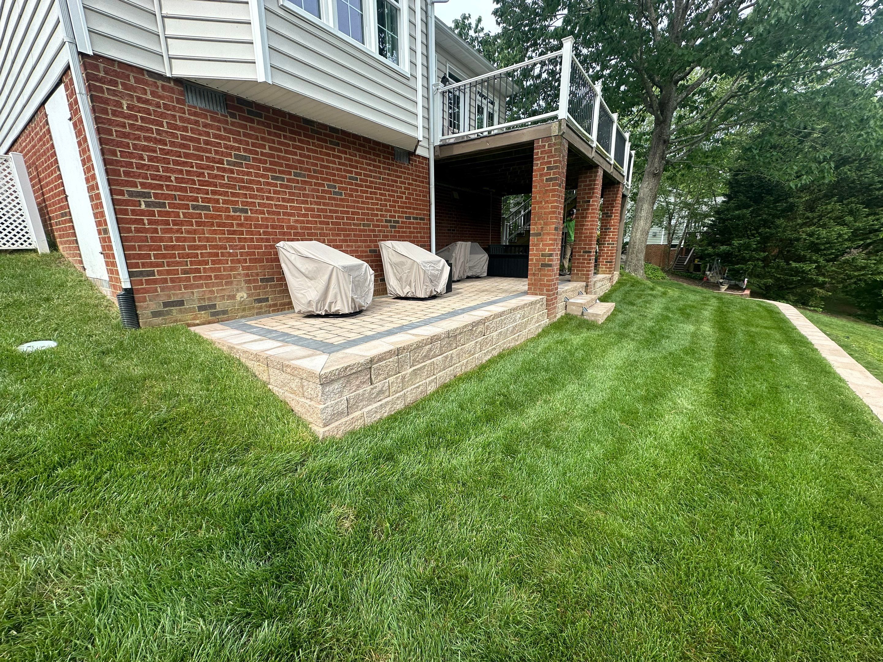 Hillside Retaining Wall & Outdoor Area by Executive Lawn and Landscape 