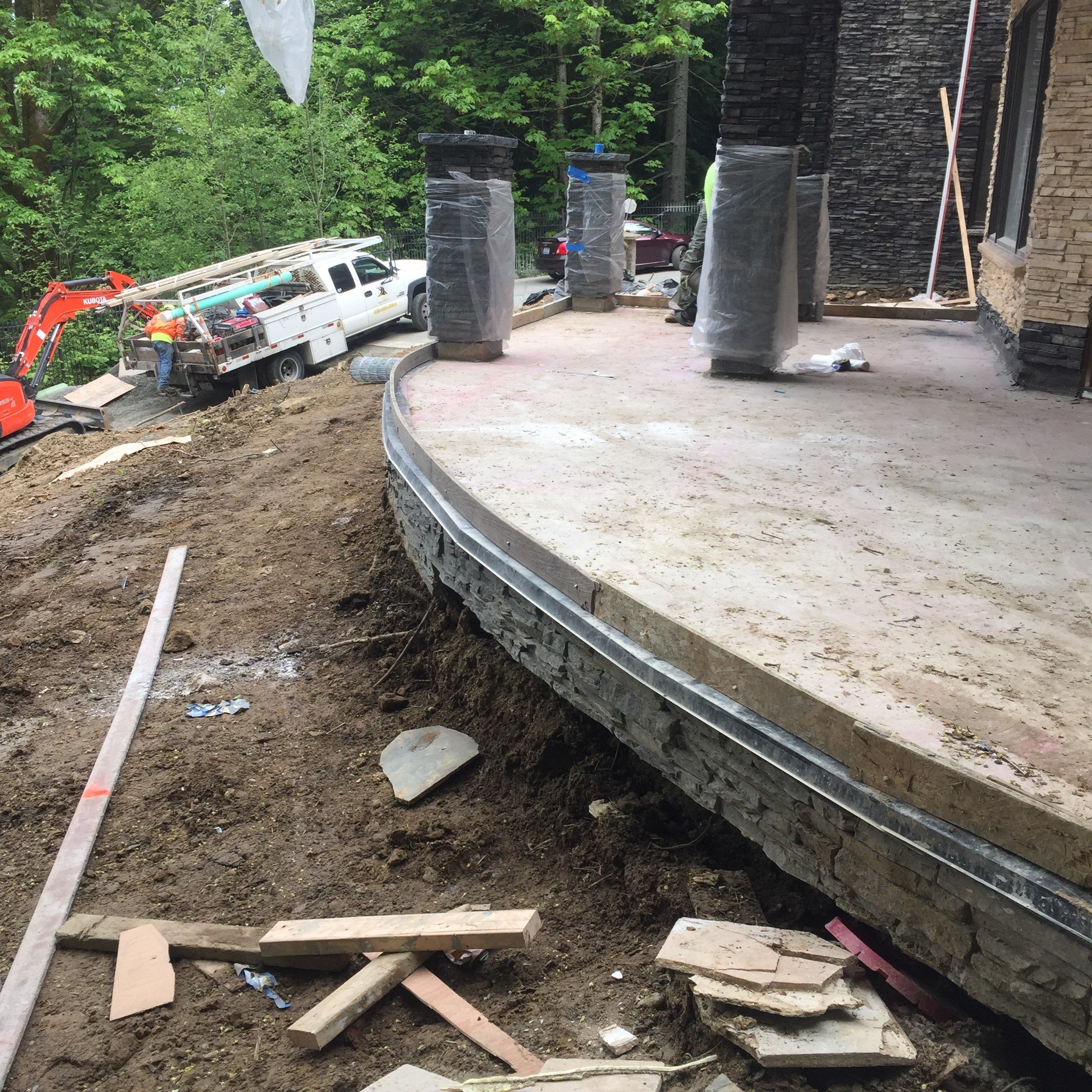 Asphalt Driveway and Stamped Concrete Patio Finish  by Jireh Asphalt & Concrete Inc 