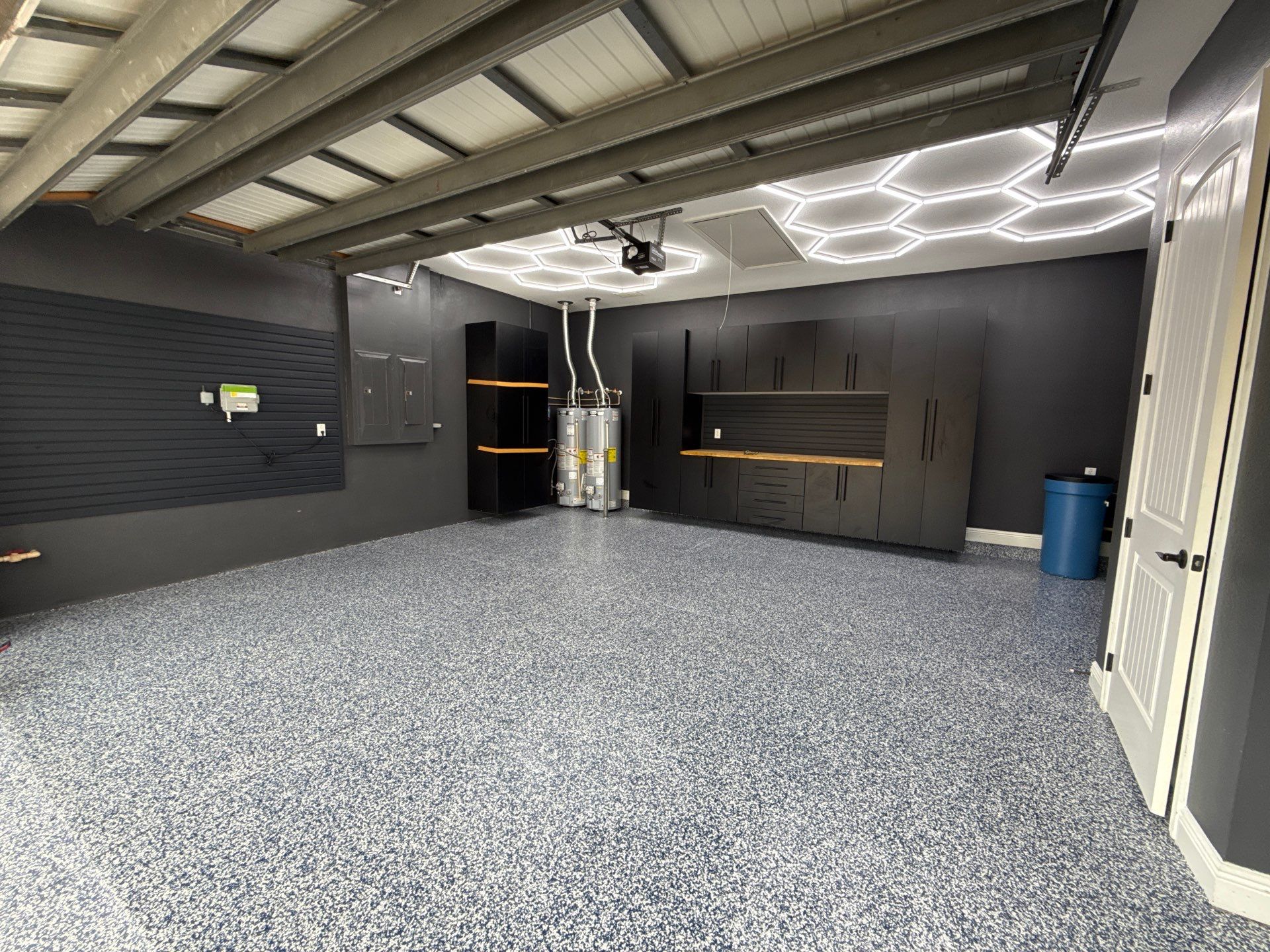 Custom Garage Makeover in Lutz Featuring Hex Lighting and Epoxy Floors by Square 1 Garage and Closet Solutions