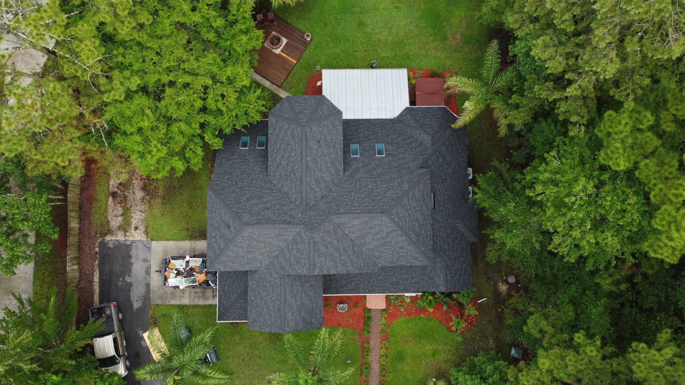 Complete Onyx Black Asphalt Shingle Roof Replacement and Skylight Installation in Jacksonville by Trinity Restoration and Roofing LLC