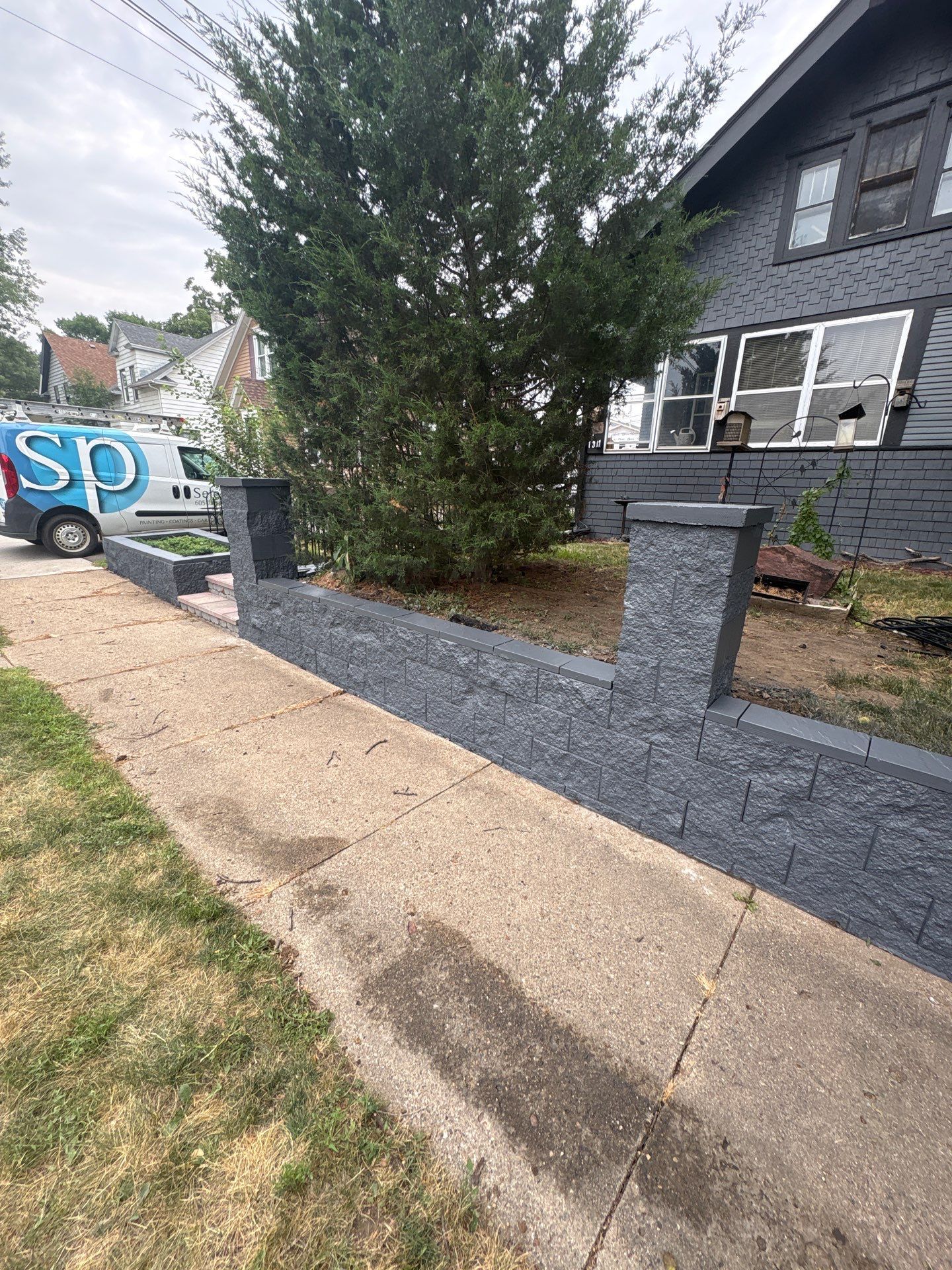 Exterior Masonry Painting for a Sioux Falls Retaining Wall by Select Painting, Coatings & Garage Cabinets