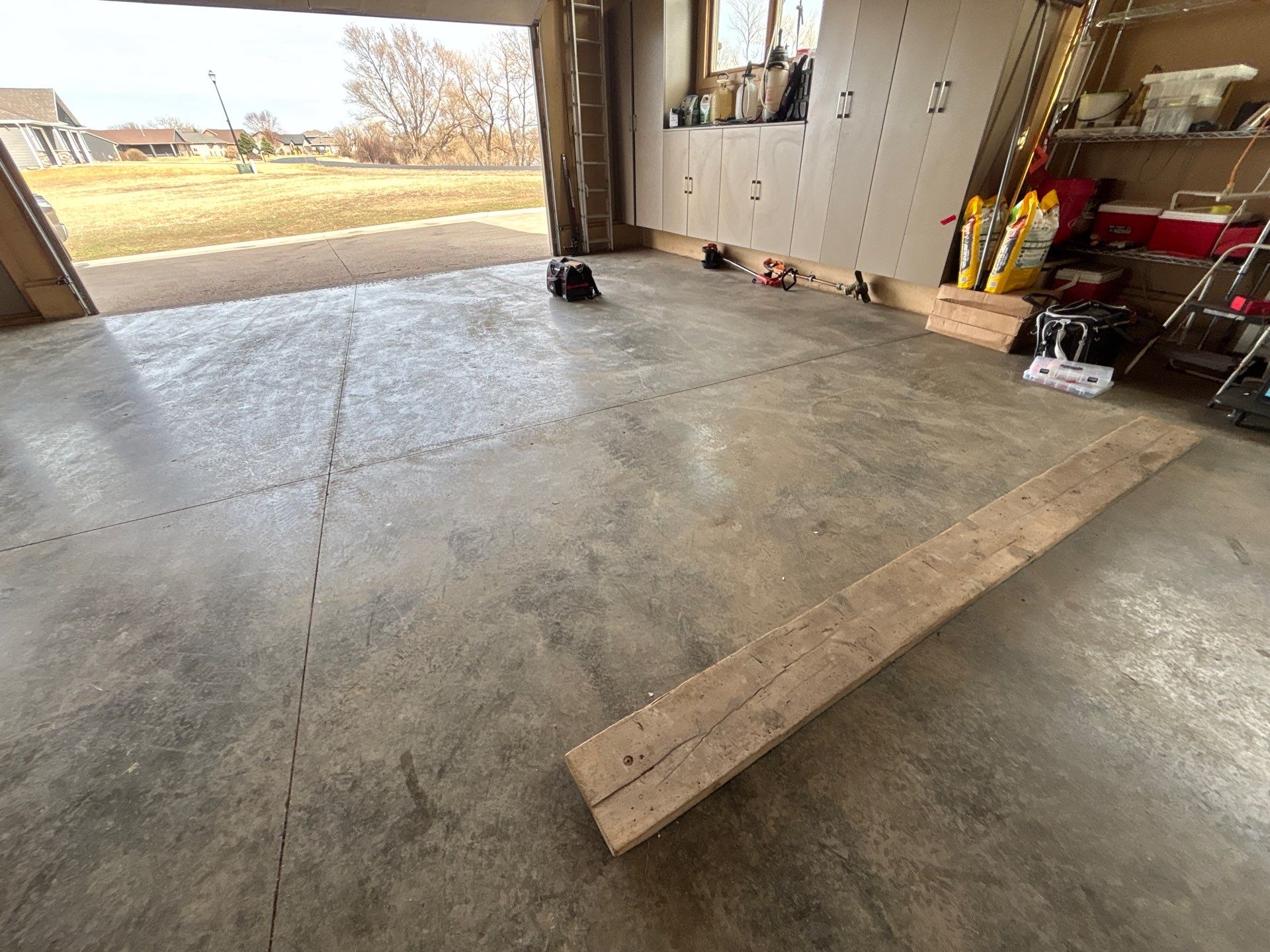 Residential Garage Floor Transformation with Speckled Epoxy Coating by Select Painting, Coatings & Garage Cabinets