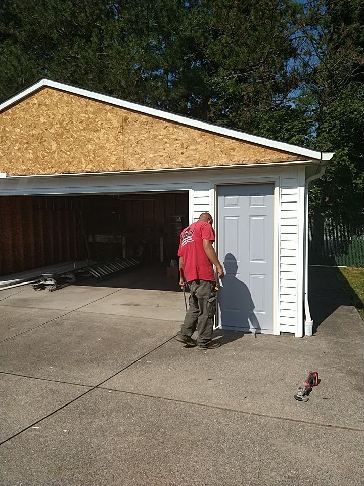 Siding Installation using Norandex woodsman dl-5 white woodgrain vinyl by Absolute Roofing and Construction