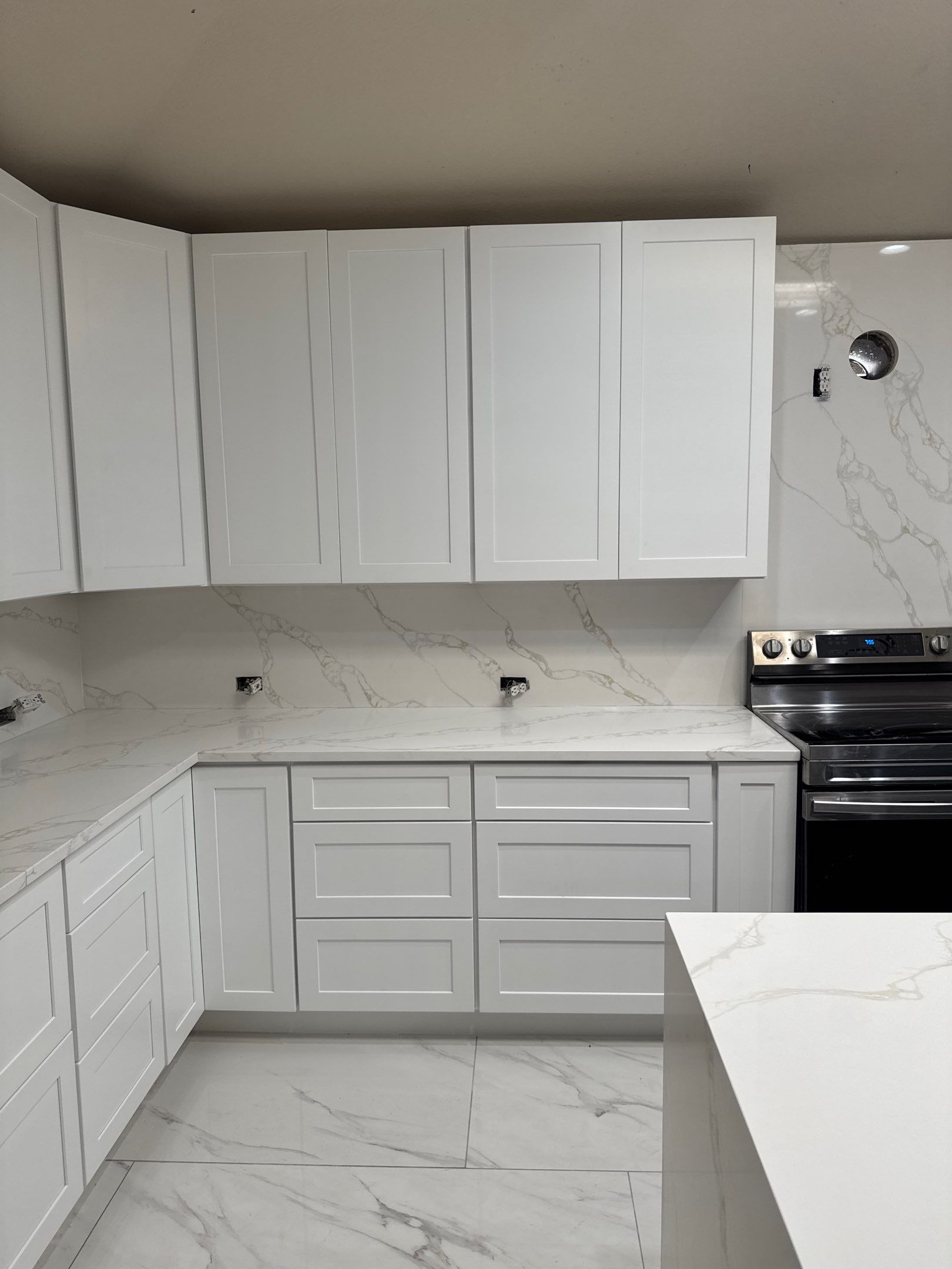 Luxury Focal Point: Full Kitchen Remodel with Double Waterfall Island by Tibi Soli LLC