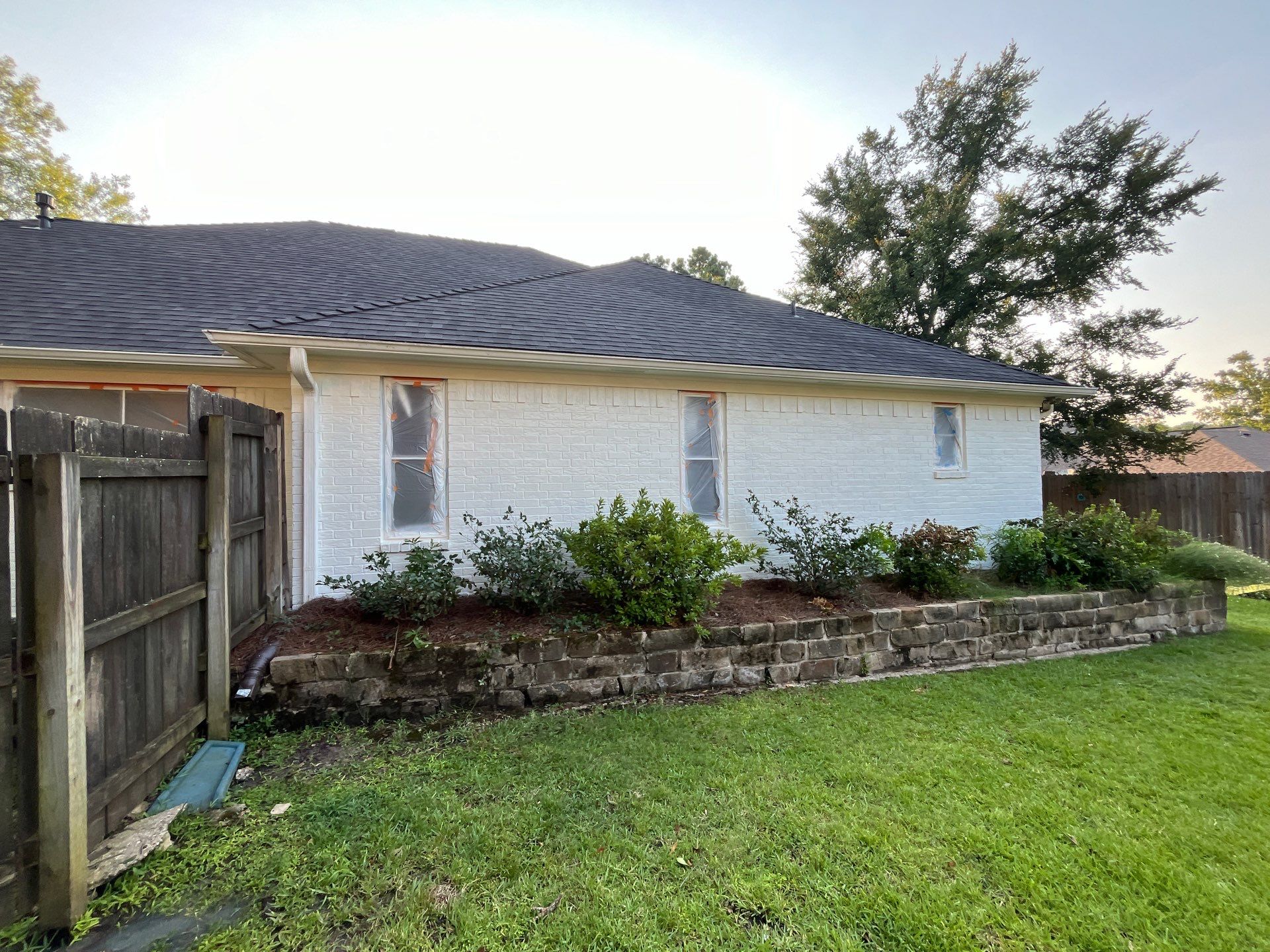 Exterior Painting in Tyler, TX | Brick House with White & Blue Finish by Quality Coats Painting