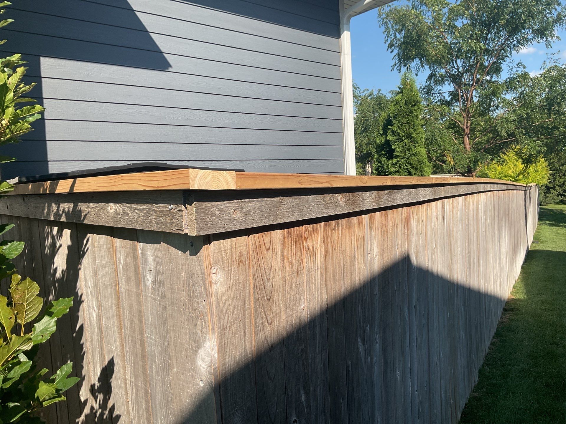 Custom Privacy Fence and Paver Patio Installation in Sioux Falls by Select Painting, Coatings & Garage Cabinets