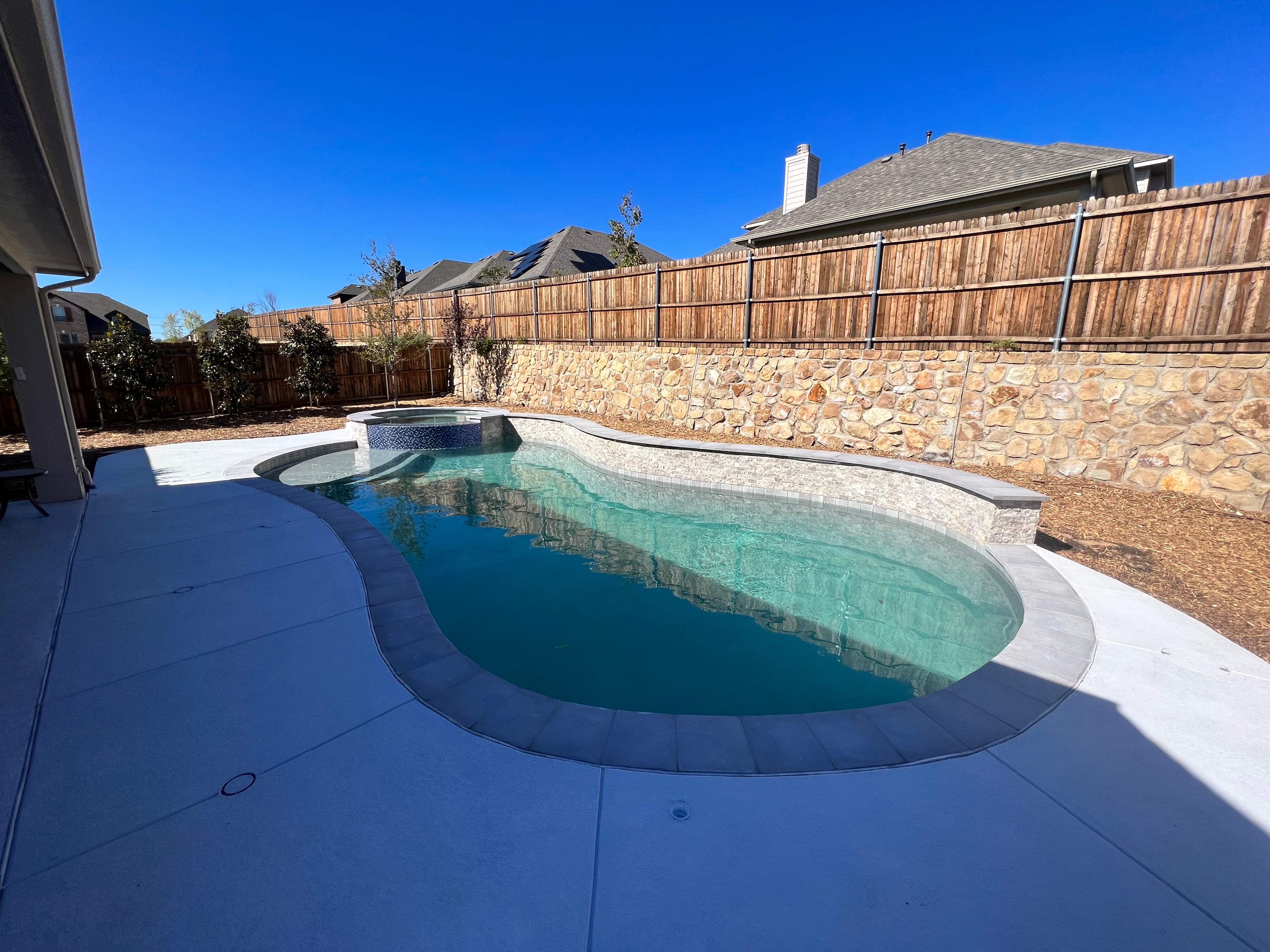 Freeform Pool with Raised Spa and Stone Coping by Pinnacle Pools and Spas - DFW