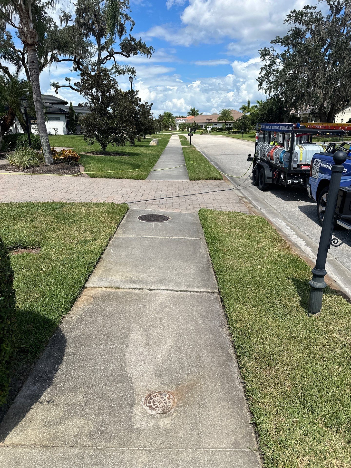 Paver Driveway, Entryway, Sidewalk, and Street Curbing Cleaning in Winding River Community, Bradenton, FL by Sunshine AquaWash