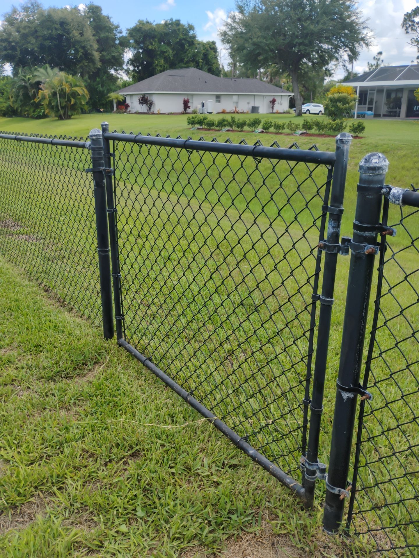 Black Vinyl-Coated Chain Link Gate Repair in North Port by True Fence LLC