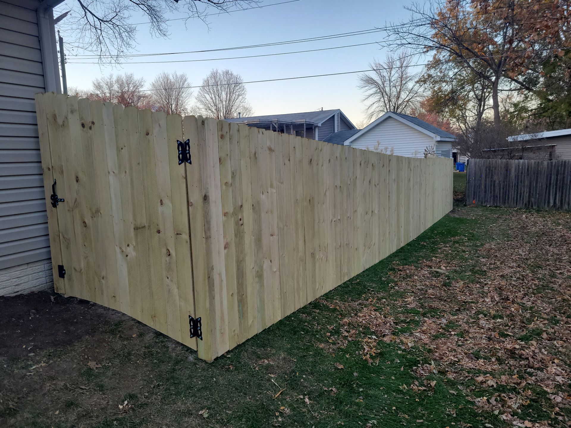 New Pressure-Treated Wood Privacy Fence and Gate in Charles City by Perfect Picket Fence and Stain