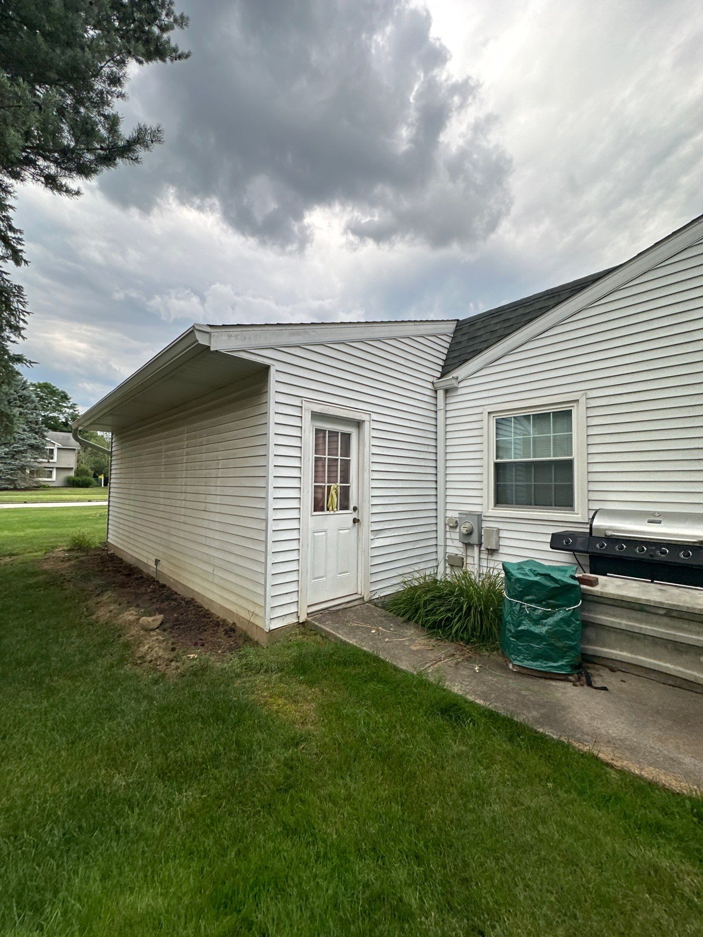 Wadsworth Exterior Transformation Featuring Blue Vertical Siding and Metal Roofing by Cornerstone Roofing And Siding