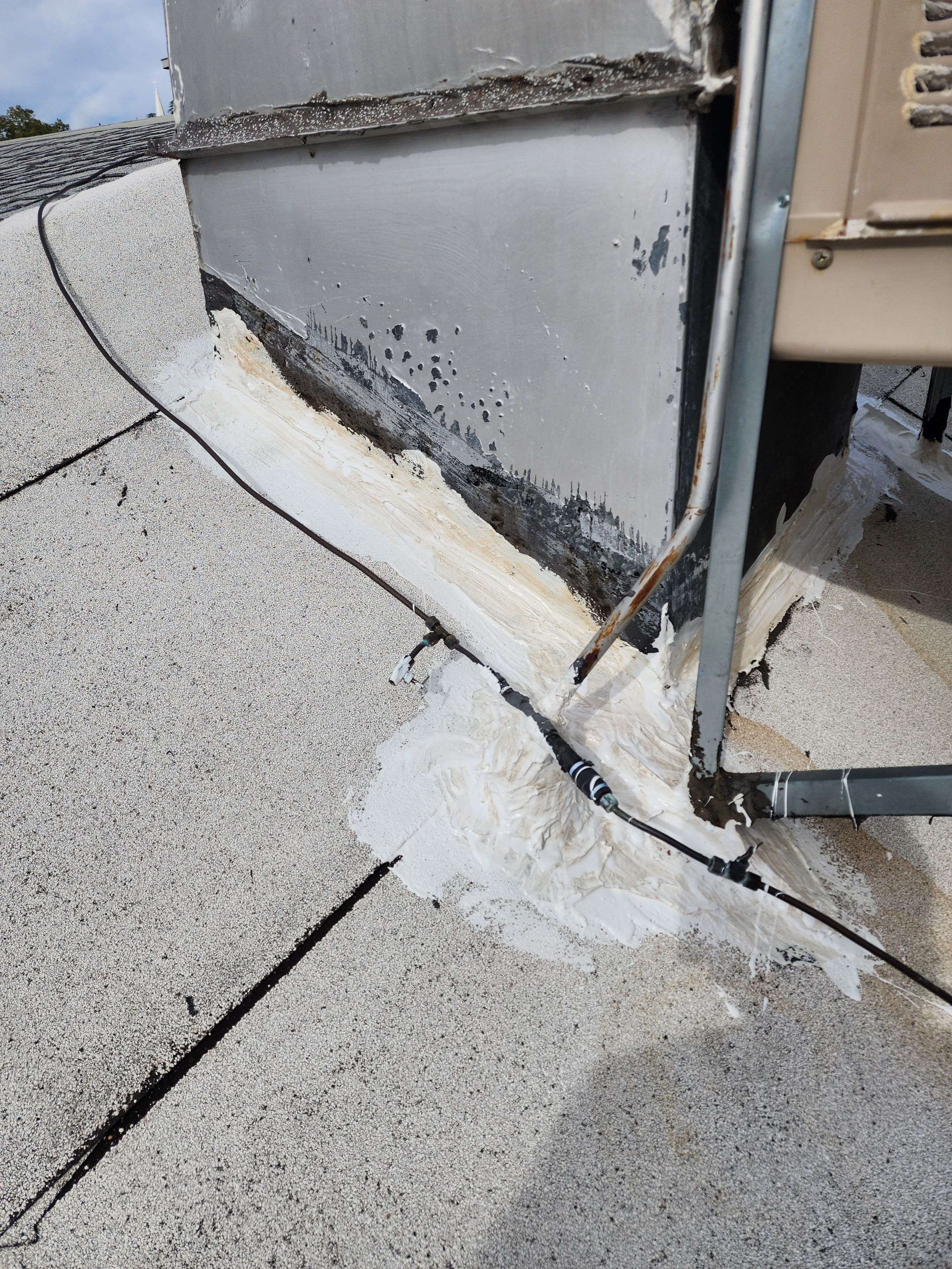 Foam and coatings on commercial roof by Straight Edge Roofing Inc