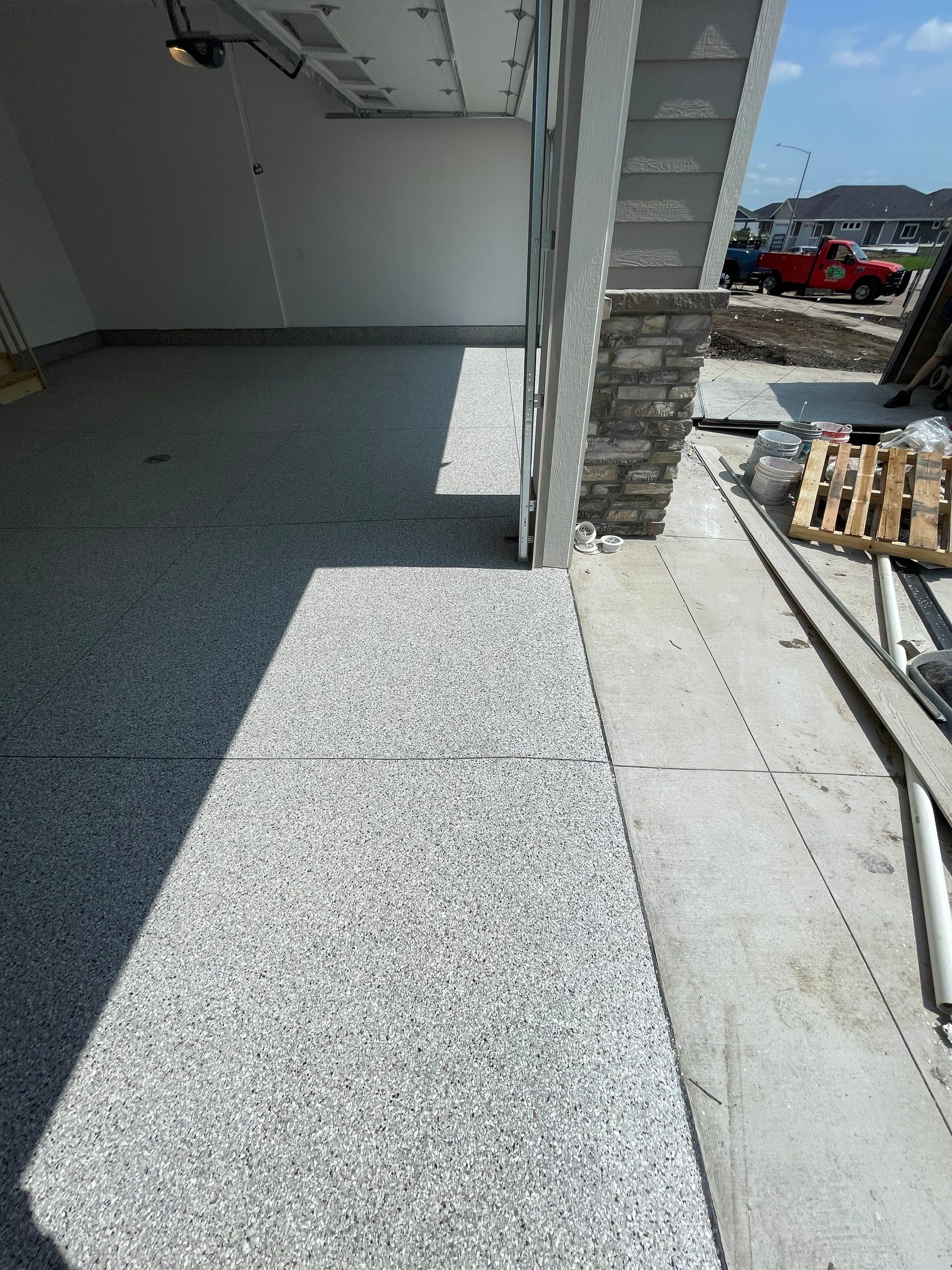 Grey Speckled Garage Floor Coating in Sioux Falls by Select Painting, Coatings & Garage Cabinets