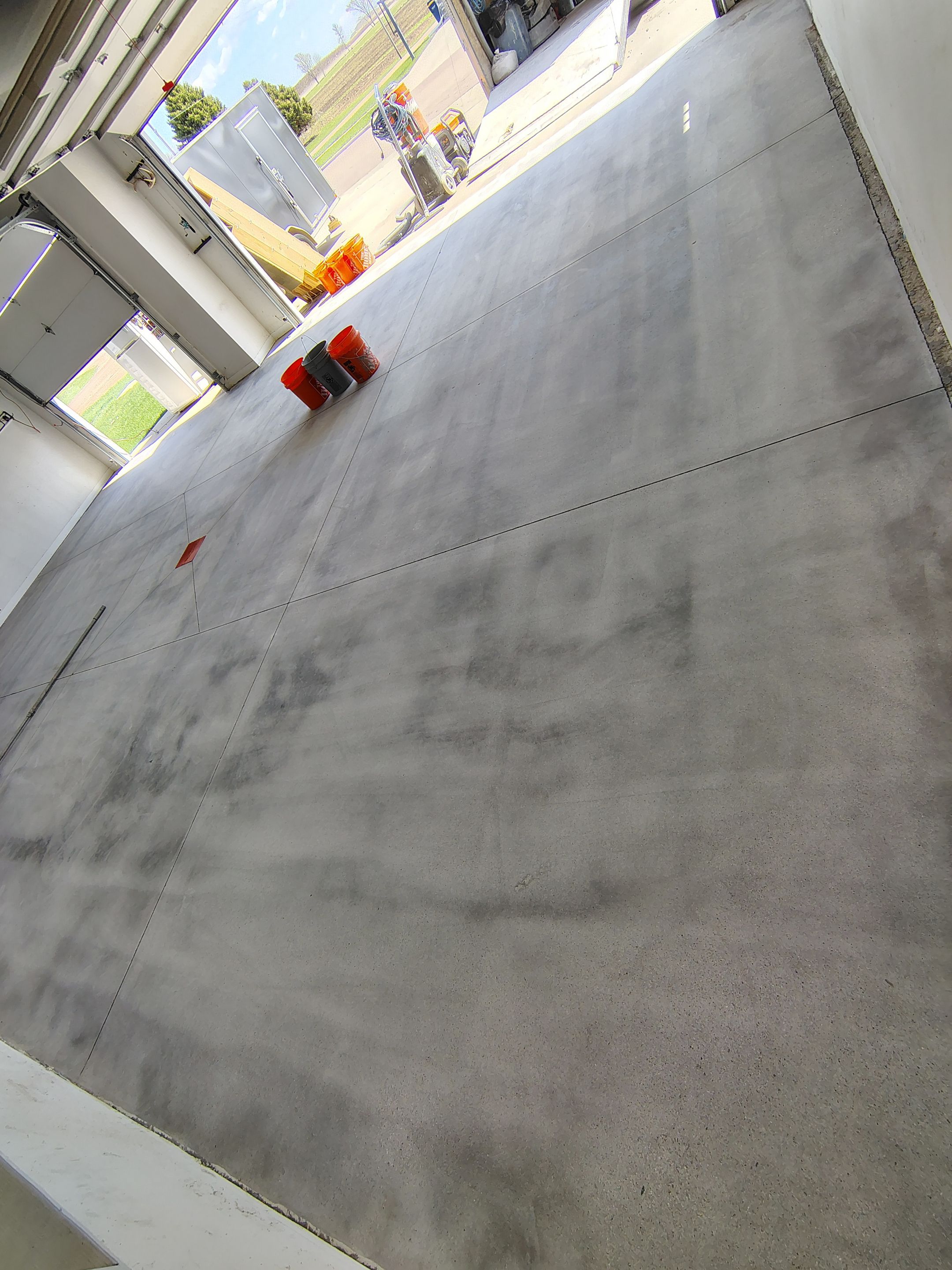Speckled Polyaspartic Garage Floor Coating Installation in Dell Rapids by Select Painting, Coatings & Garage Cabinets