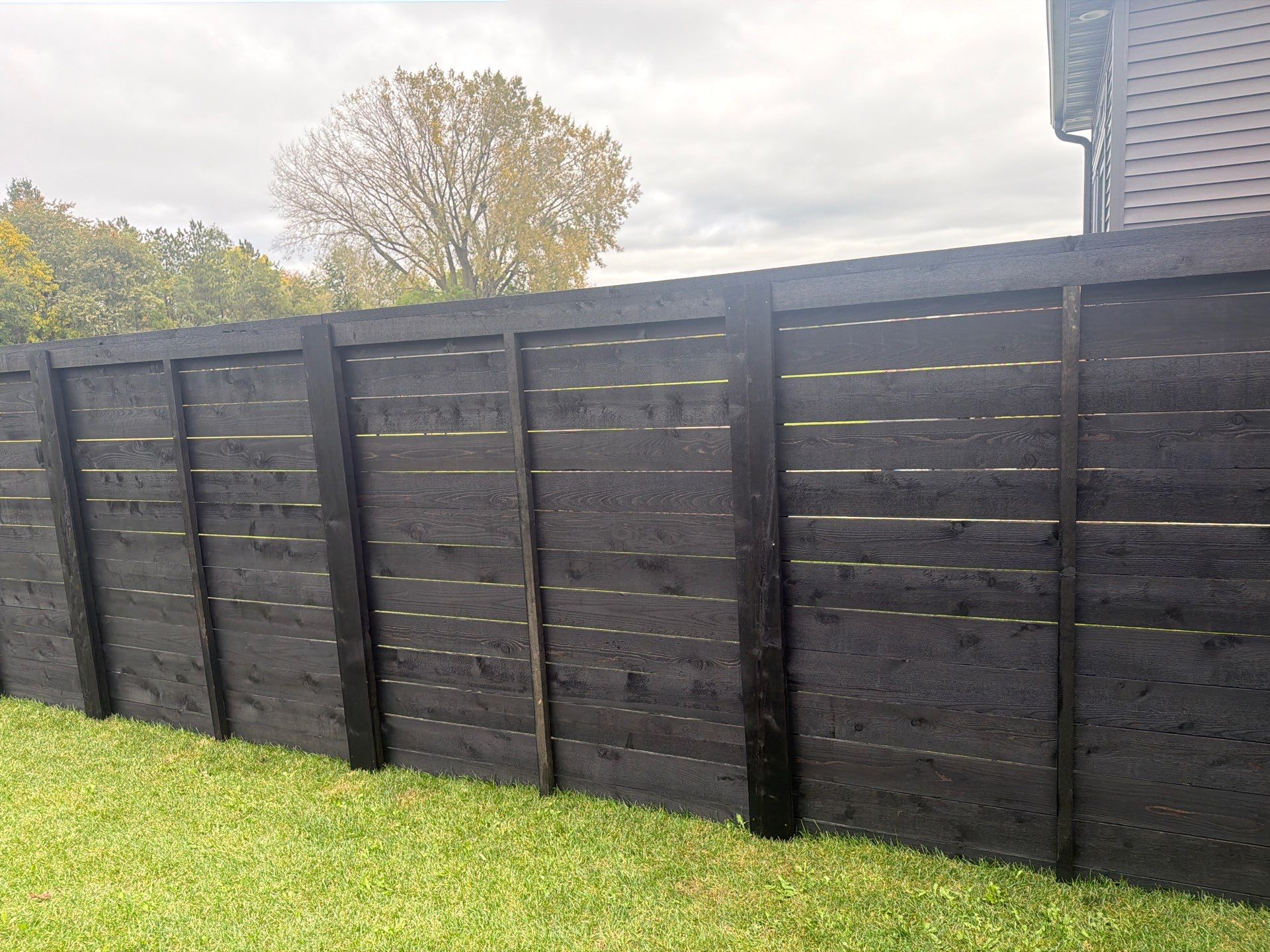 Modern Horizontal Wood Privacy Fence Installation in Cedar Falls by Perfect Picket Fence and Stain