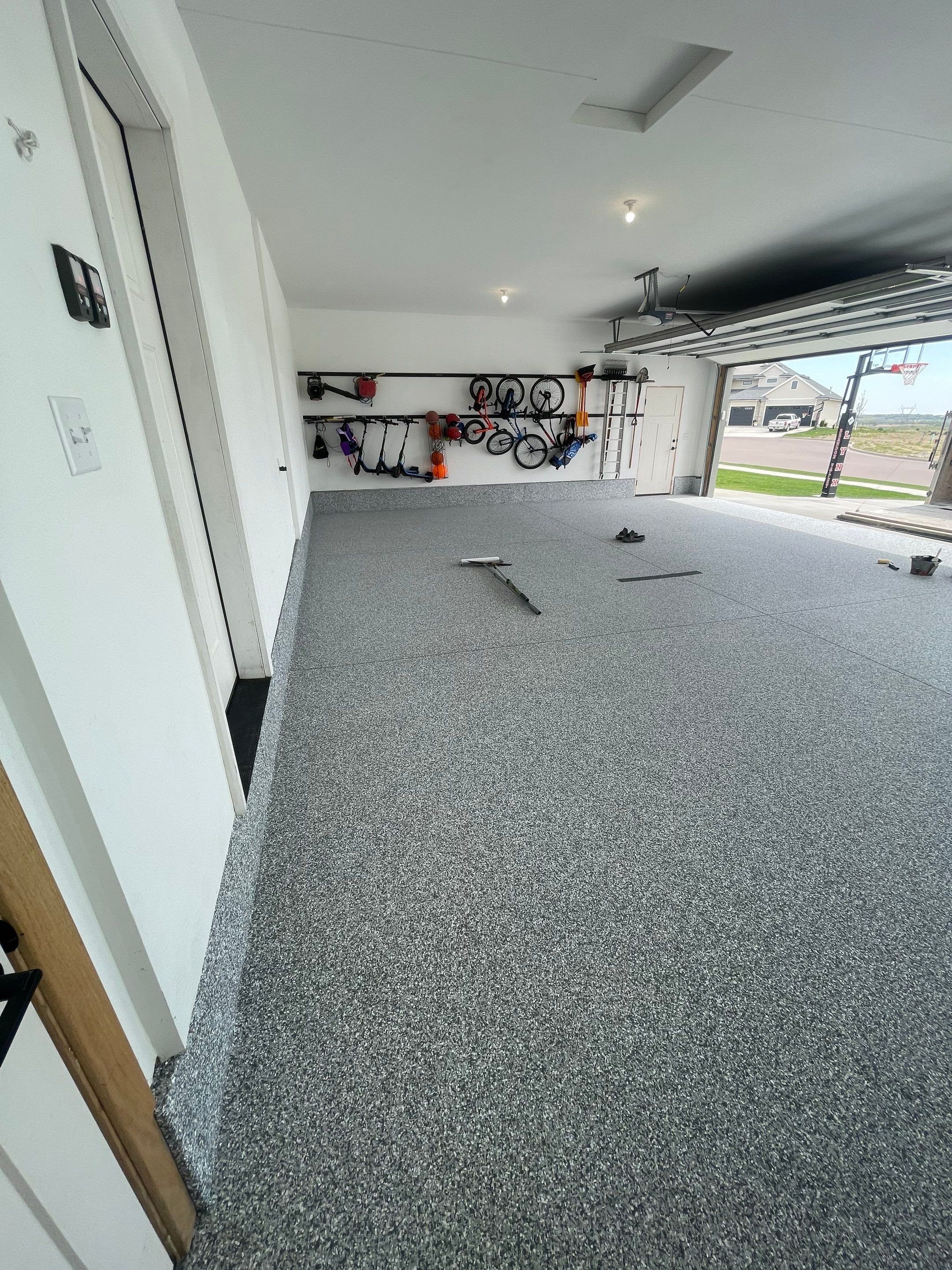 Full Garage Concrete Coating with Grey Speckled Epoxy in Brandon by Select Painting, Coatings & Garage Cabinets