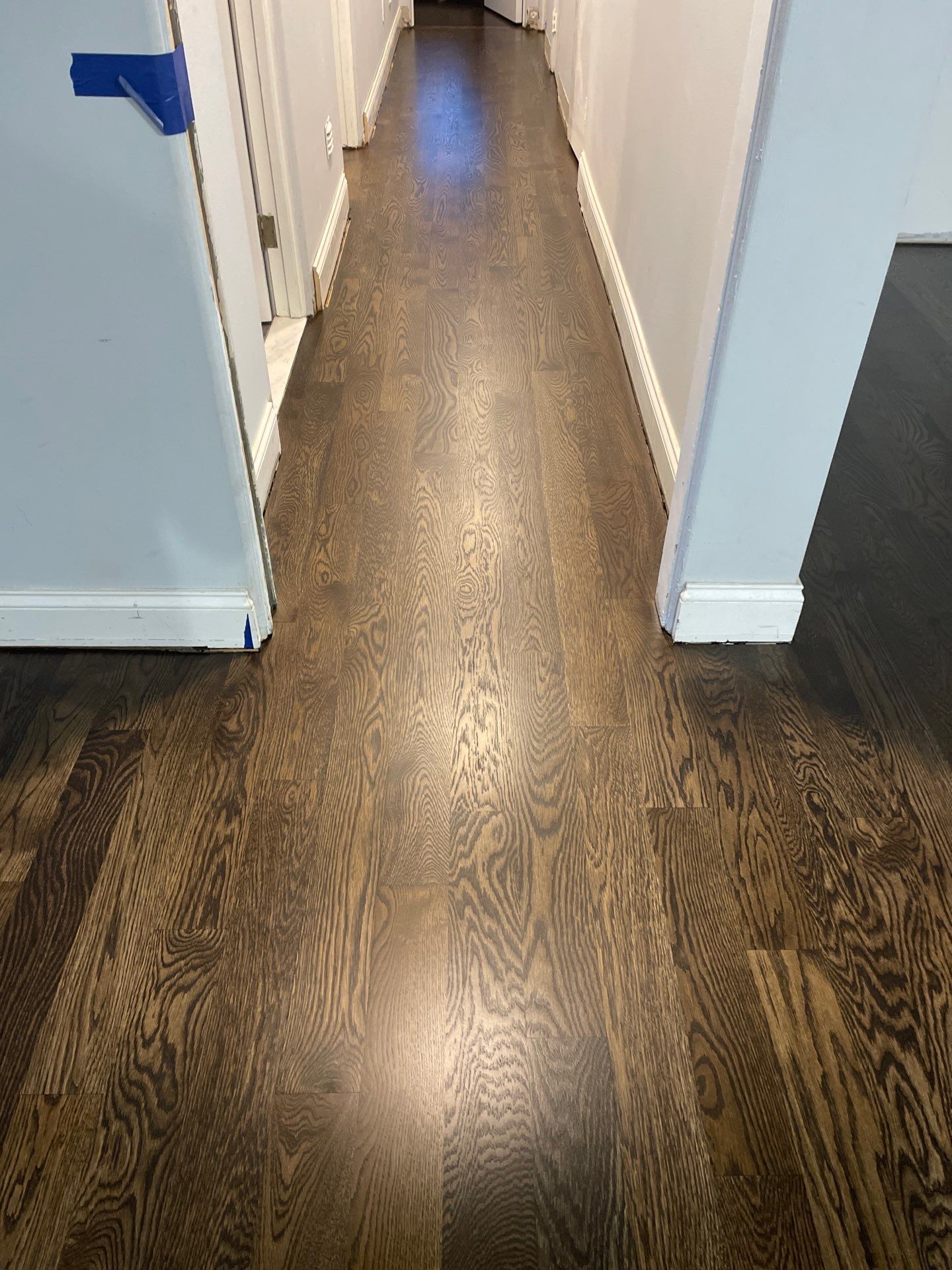New Flooring installation using 4" White oak select grade plain sawn Ebony Stain by Ann Arbor Hardwoods