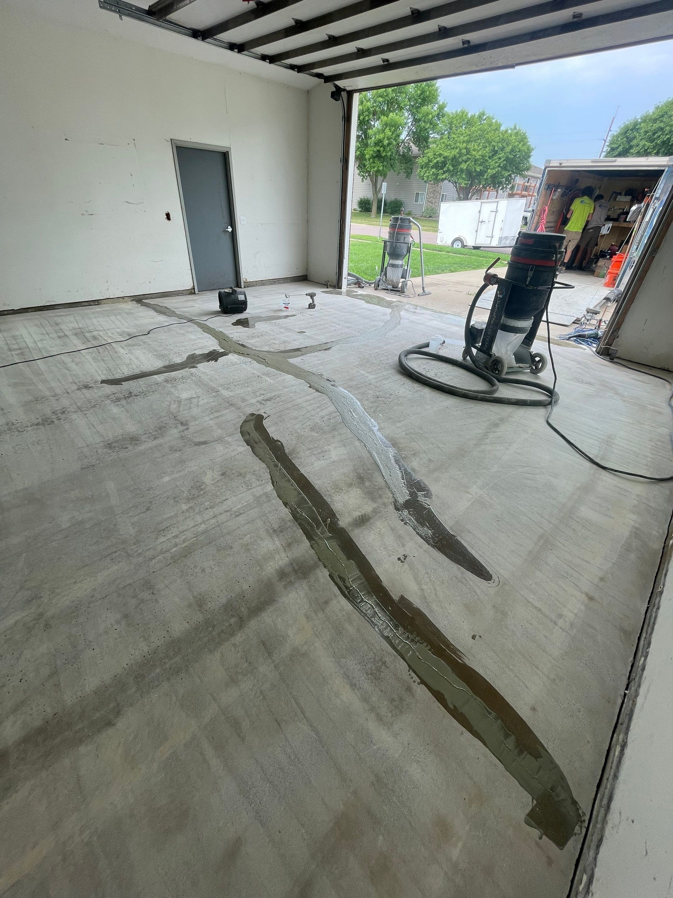 Coyote Flake Concrete Coating for Sioux Falls Garage by Select Painting, Coatings & Garage Cabinets