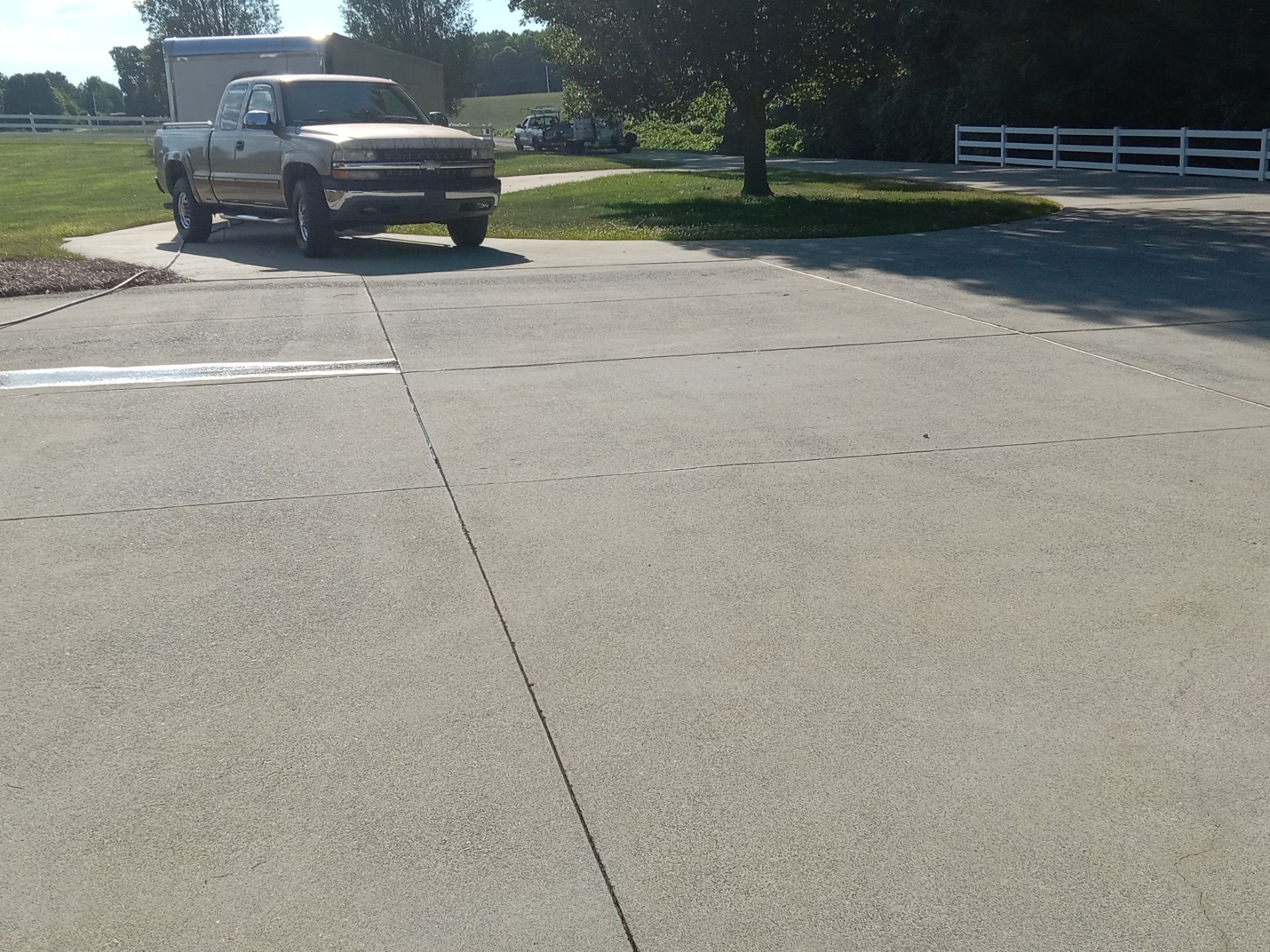 pressure washing company cleaning concrete driveway removing dirt buildup for a refreshed appearance