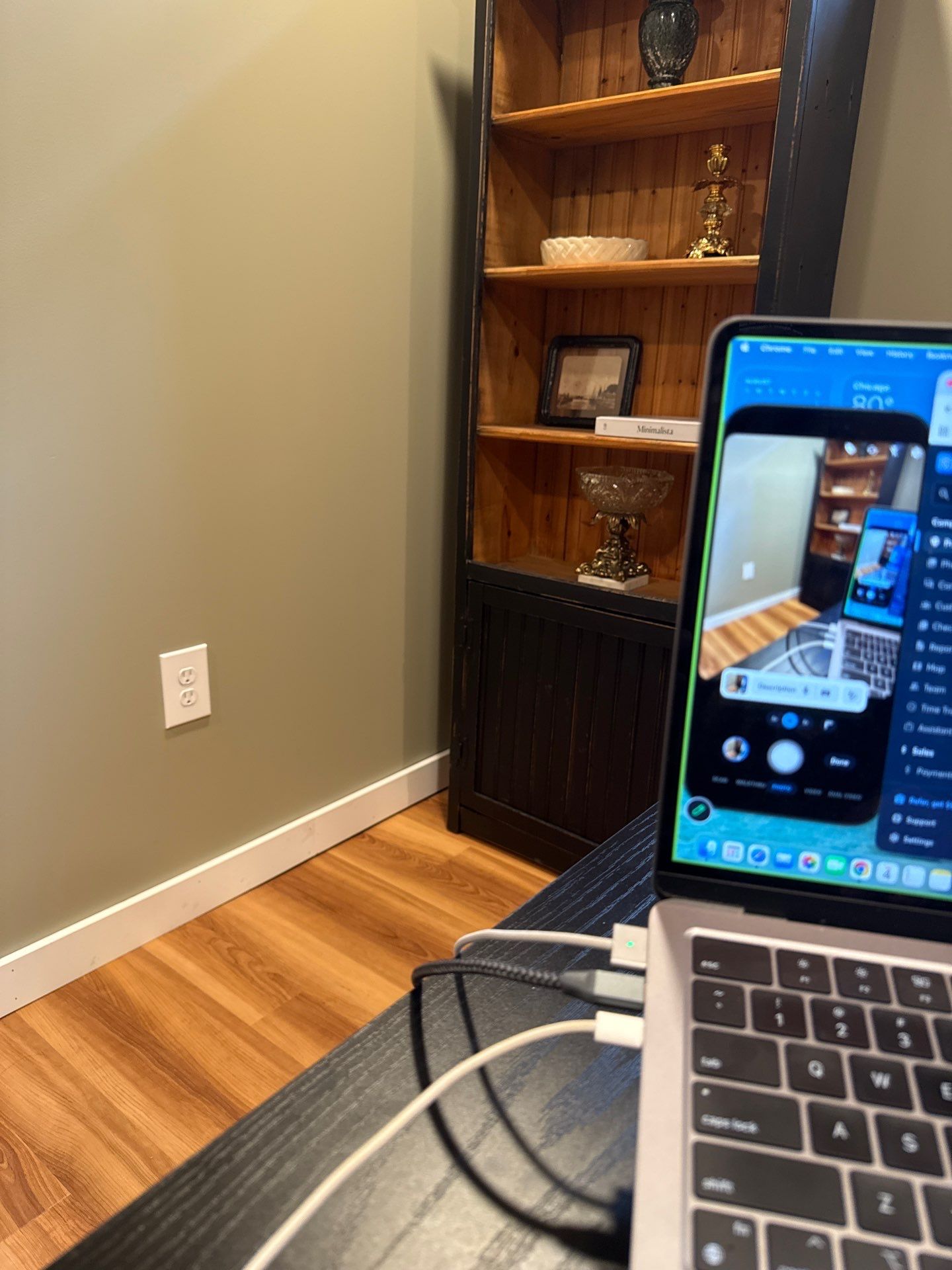 Home Office Setup with Sage Walls and Dark Wood Shelving by CompanyCam Sales Demo