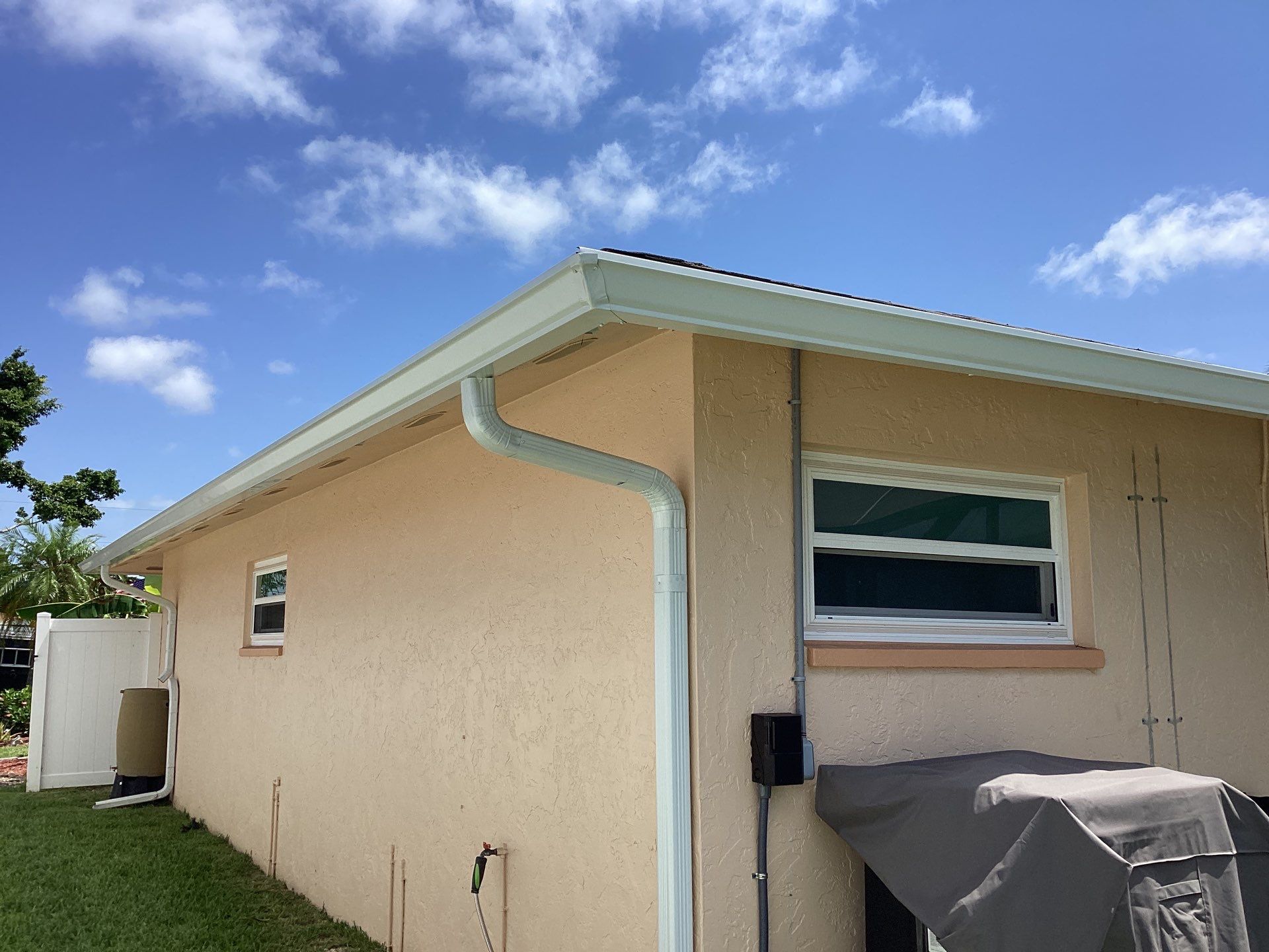 White K Style Seamless Gutters using 3X4 Elbow Downspout in Cape Coral FL by Gutter Professors